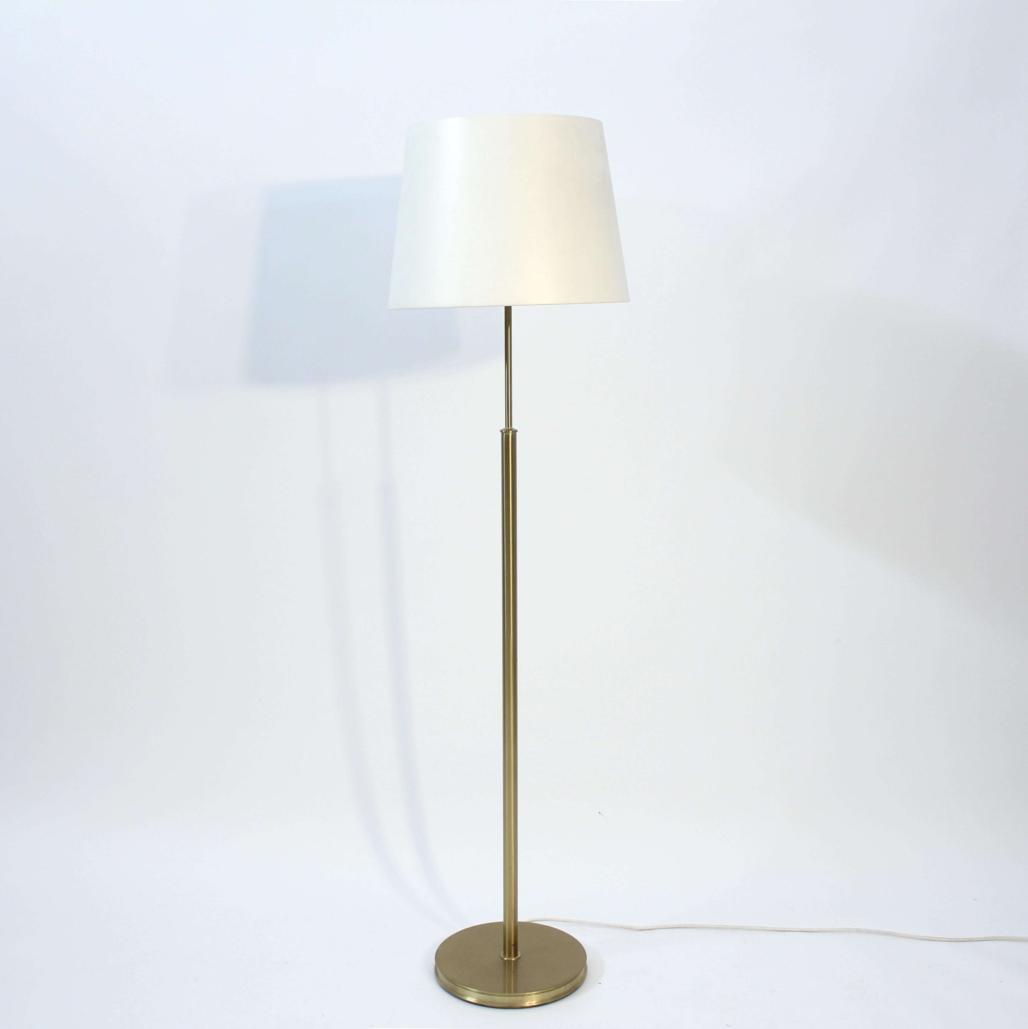 Floor lamp in brass, model 2148, designed by Josef Frank for Svenskt Tenn in the 1940s. This example is most likely from the 1980s. All the brass is in a very good condition with light ware consistent with age and use. The shade is in overall in