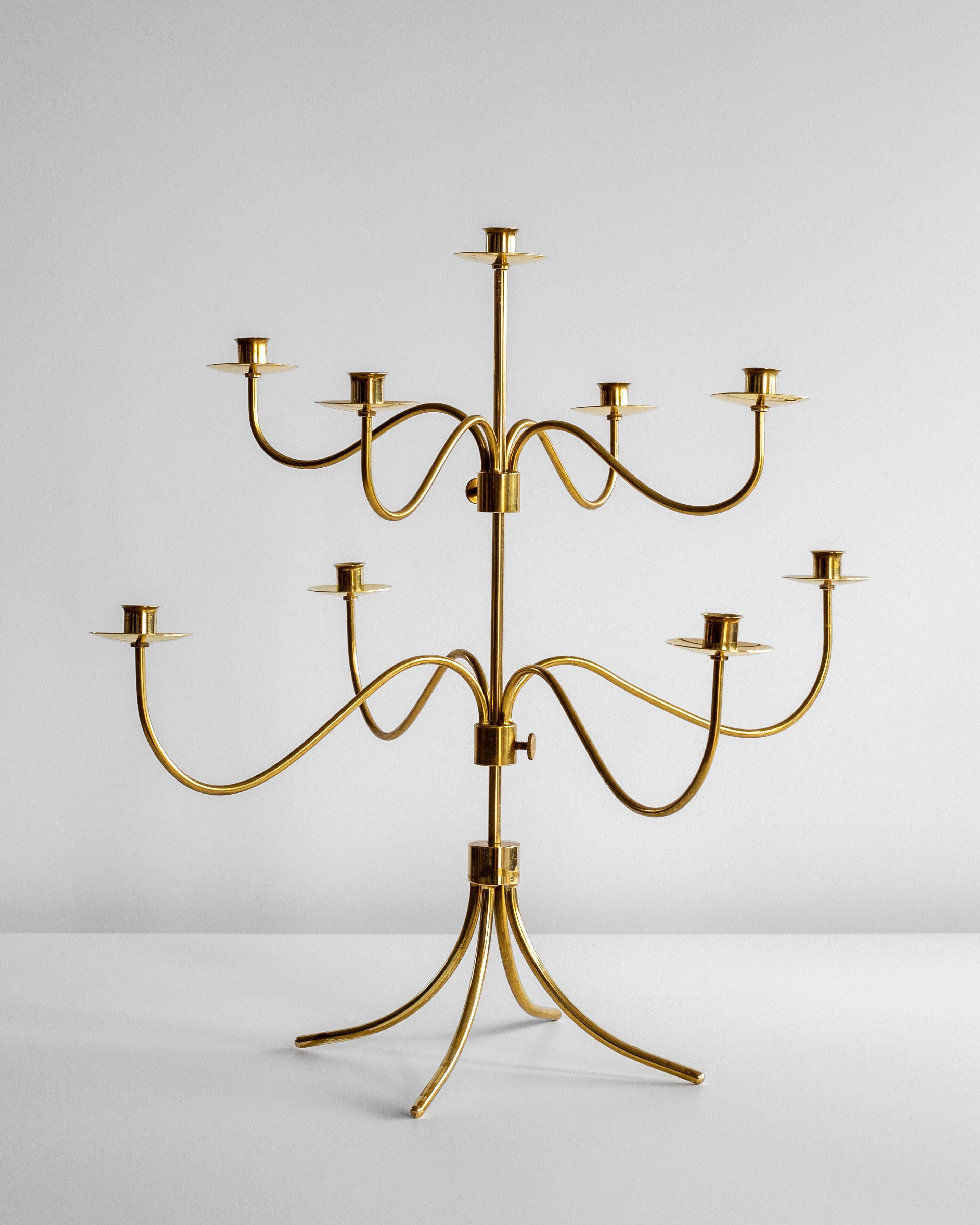 A large and majestic brass candelabra from the 1940s, attributed to the esteemed designer Josef Frank for Svenskt Tenn, the legendary Stockholm-based interior design firm founded in 1924.

This graceful brass centerpiece holds nine candles and