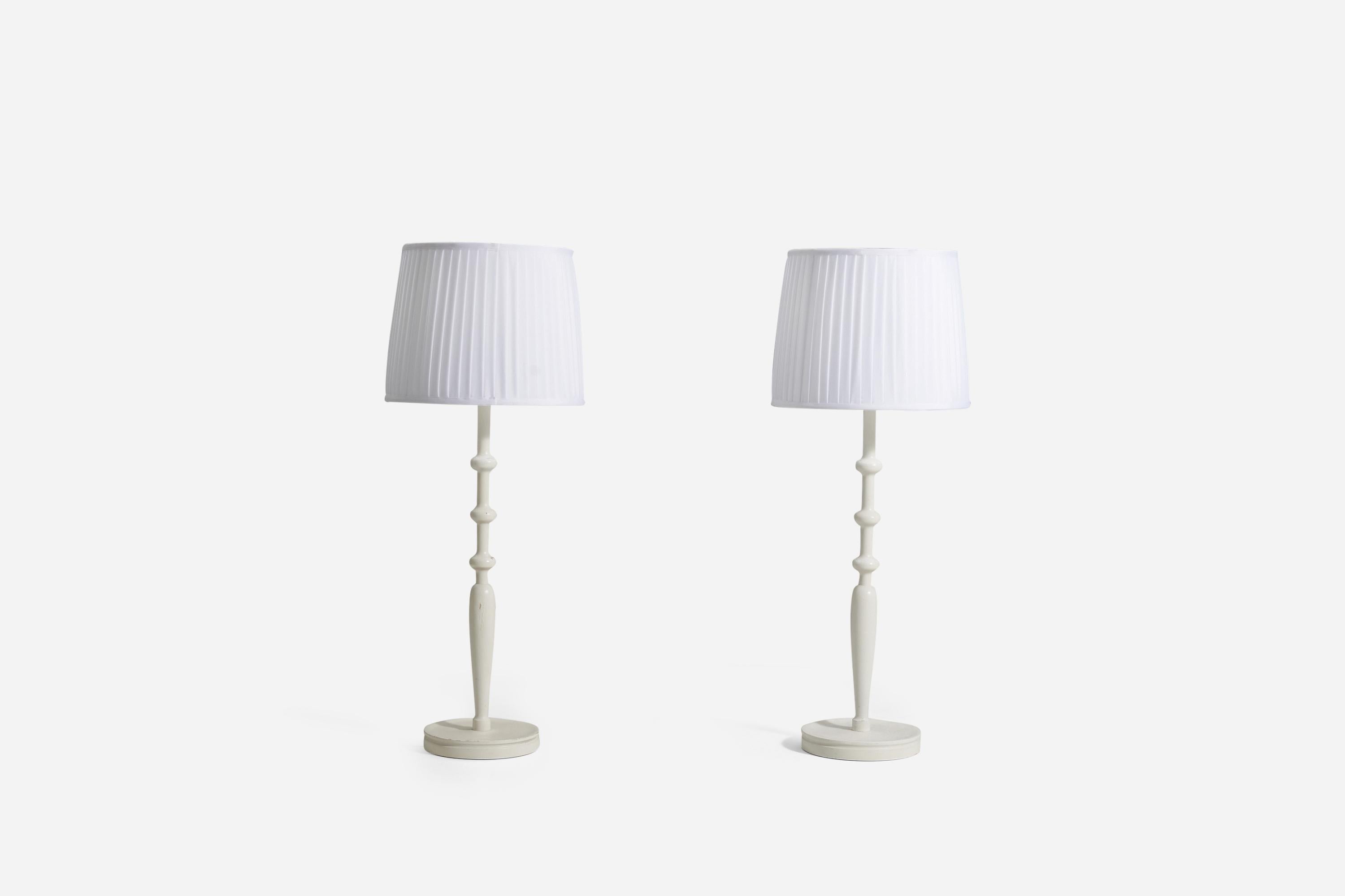 A pair of large table lamps for Svenskt Tenn, Stockholm, Sweden. In painted turned wood.

Lampshades are not included, stated dimensions are without lampshades.

Other lighting designers of the period include Paavo Tynell, Alvar Aalto, Serge