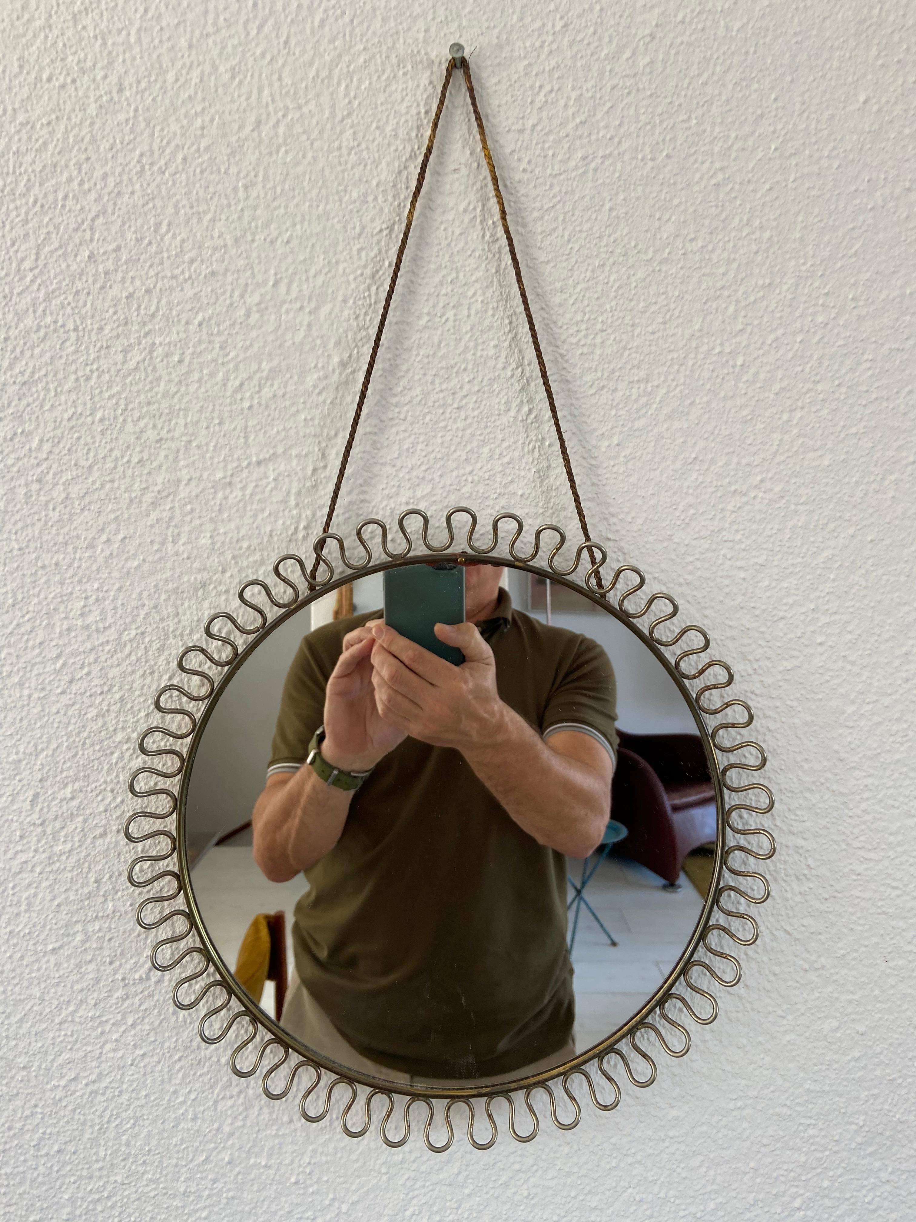 Josef Frank mirror in brass with the original hanging rope.
The condition is good, but there is a very small chip at the edge of the mirror glass. Easy to replace glass, but not really necessary.