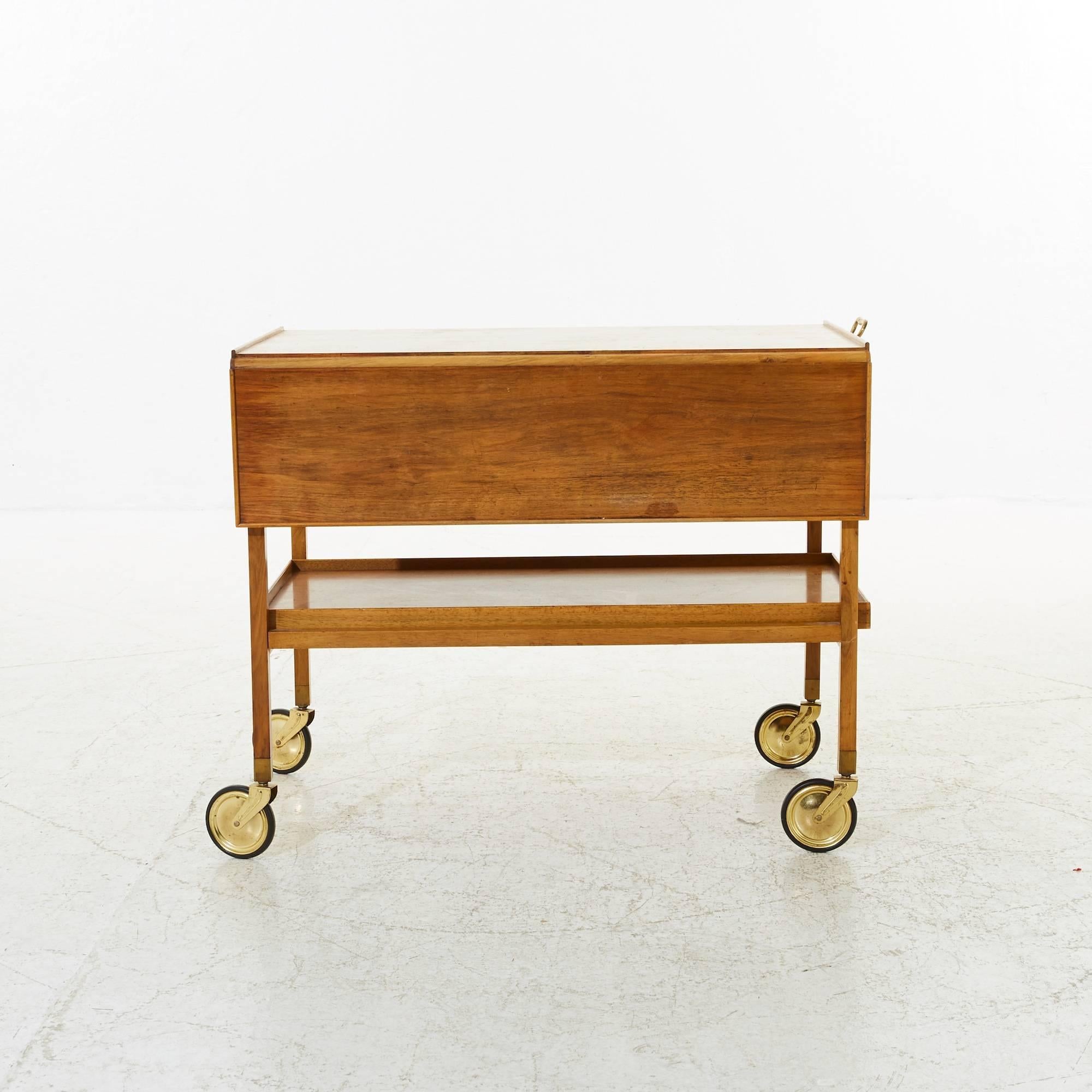 Josef Frank walnut wood trolley with brass handle and brass/rubber wheels. Tray removable, folding top. Producer: Kold Christensen.
Folding top width 50 - 90 cm.