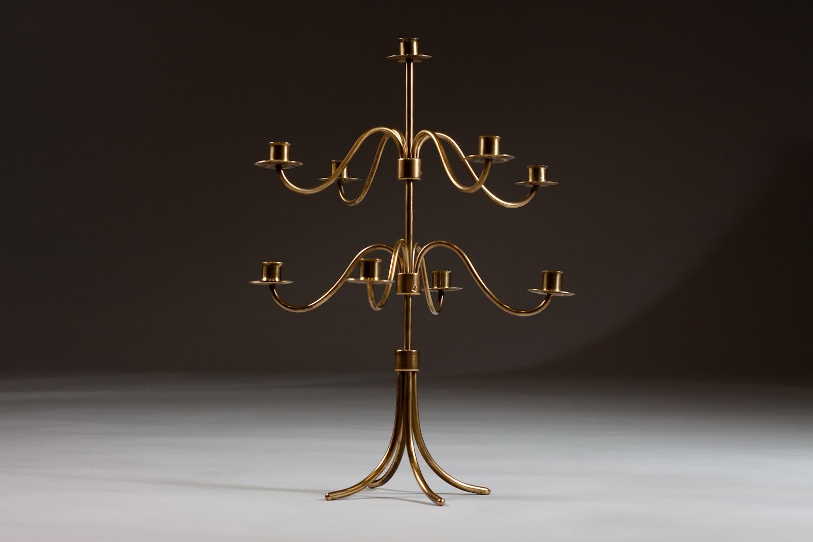Beautiful adjustable brass candelabra by the famous designer Josef Frank from Sweden designed for Svenskt Tenn. The candelabra can hold 9 candles and due to its size, is an eye-catcher in any modern interior design.