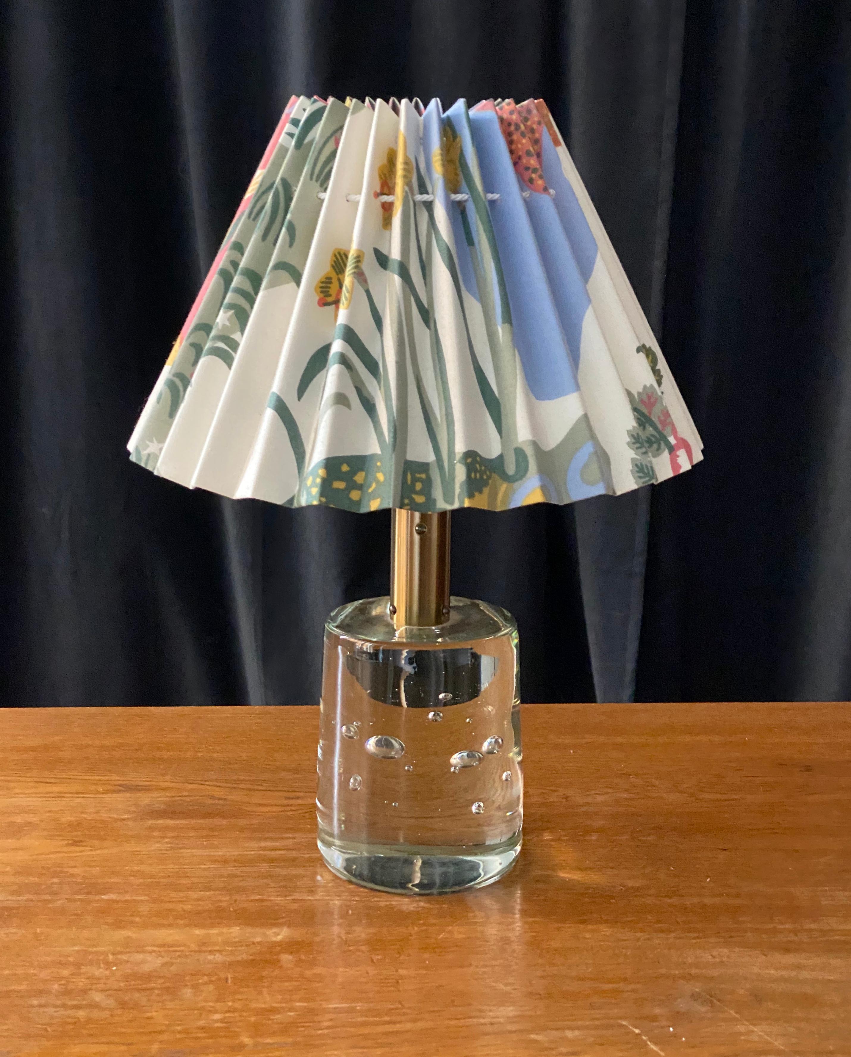 A table lamp by Josef Frank, in brass and studio glass from Reijmyre Glasbruk. Fabric screen also designed by Josef Frank, possibly updated at some point. Produced by Svenskt Tenn, 1960s.

Other lighting designers of the period include Hans-Agne
