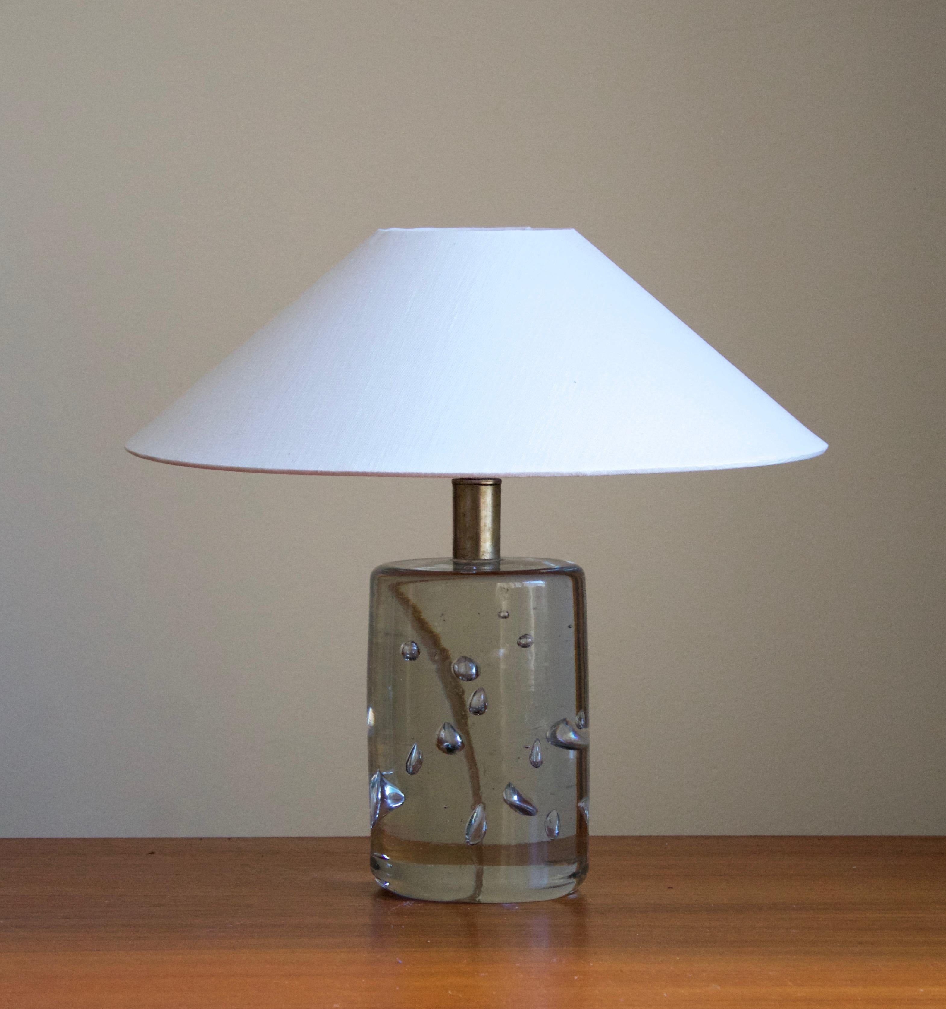 An early and sizable version table lamp by Josef Frank, in brass and studio glass from Reijmyre Glasbruk. Produced by Svenskt Tenn, 1950s.

Stated dimensions excluding lampshade. Sold without lampshade.

Other lighting designers of the period