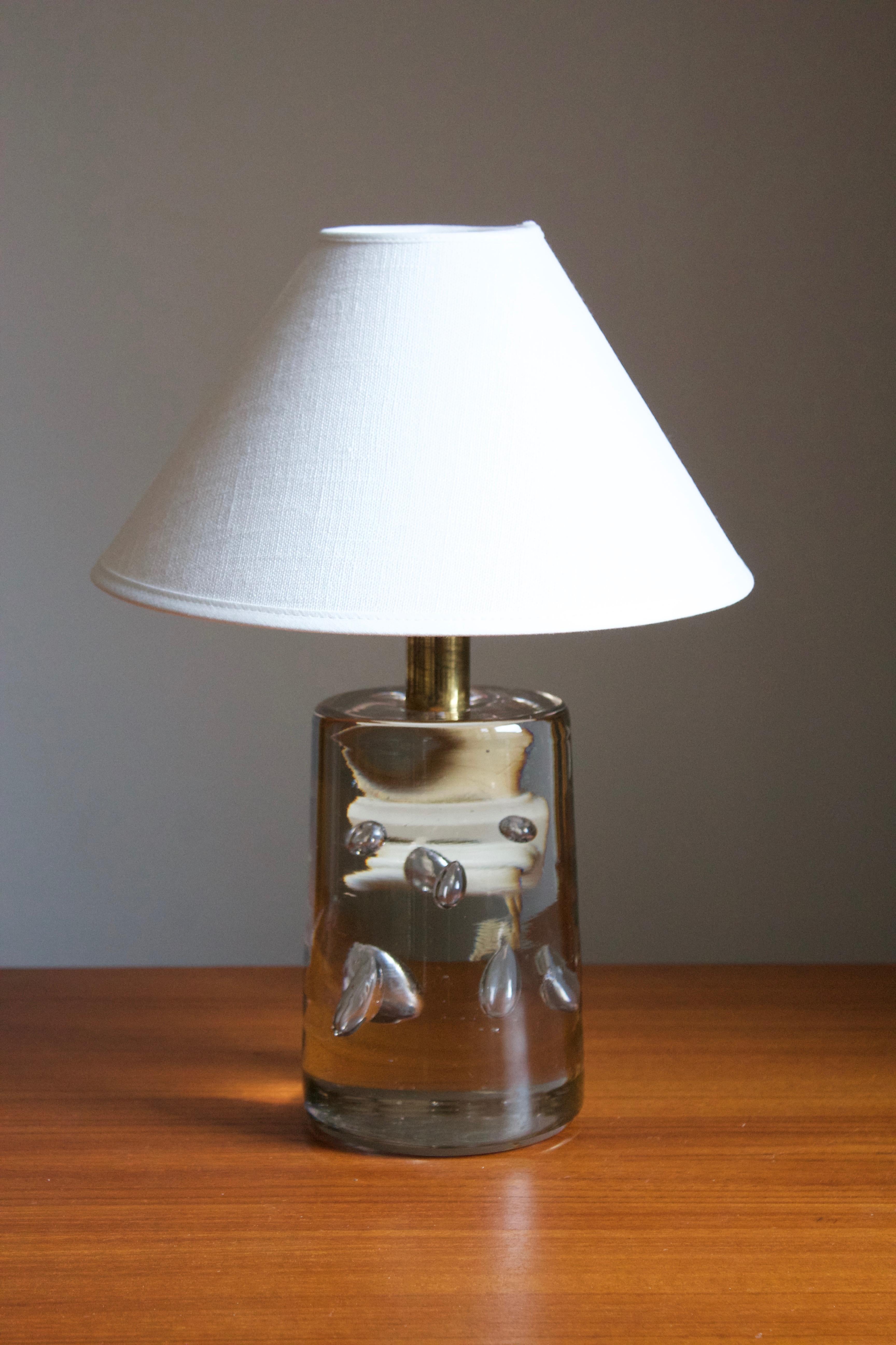 An early and sizable version table lamp by Josef Frank, in brass and studio glass from Reijmyre Glasbruk. Produced by Svenskt Tenn, 1960s.

Stated dimensions excluding lampshade. Sold without lampshade.

Other lighting designers of the period