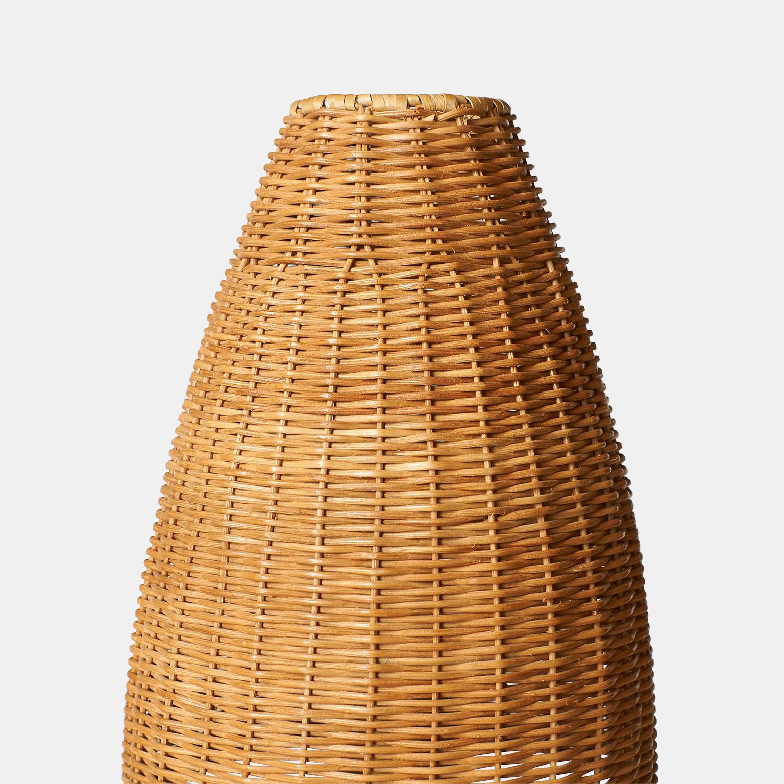 A brass coated pewter lamp by Josef Frank for Svenskt Tenn. Model #2332. Conical wicker shade of later vintage. Two available. Only one shade.  

