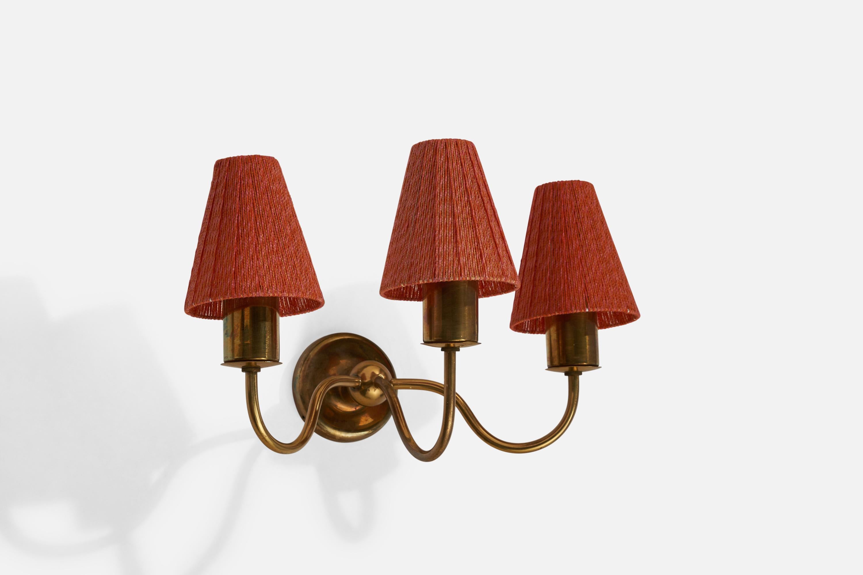 A three-armed brass and red string-fabric wall light designed by Josef Frank and produced by Svenskt Tenn, Sweden, 1940s.

Overall Dimensions (inches): 10.5” H x 15.5” W x 10.5” D
Back Plate Dimensions (inches): 3.75” H x 3.75” W x .75” D
Bulb