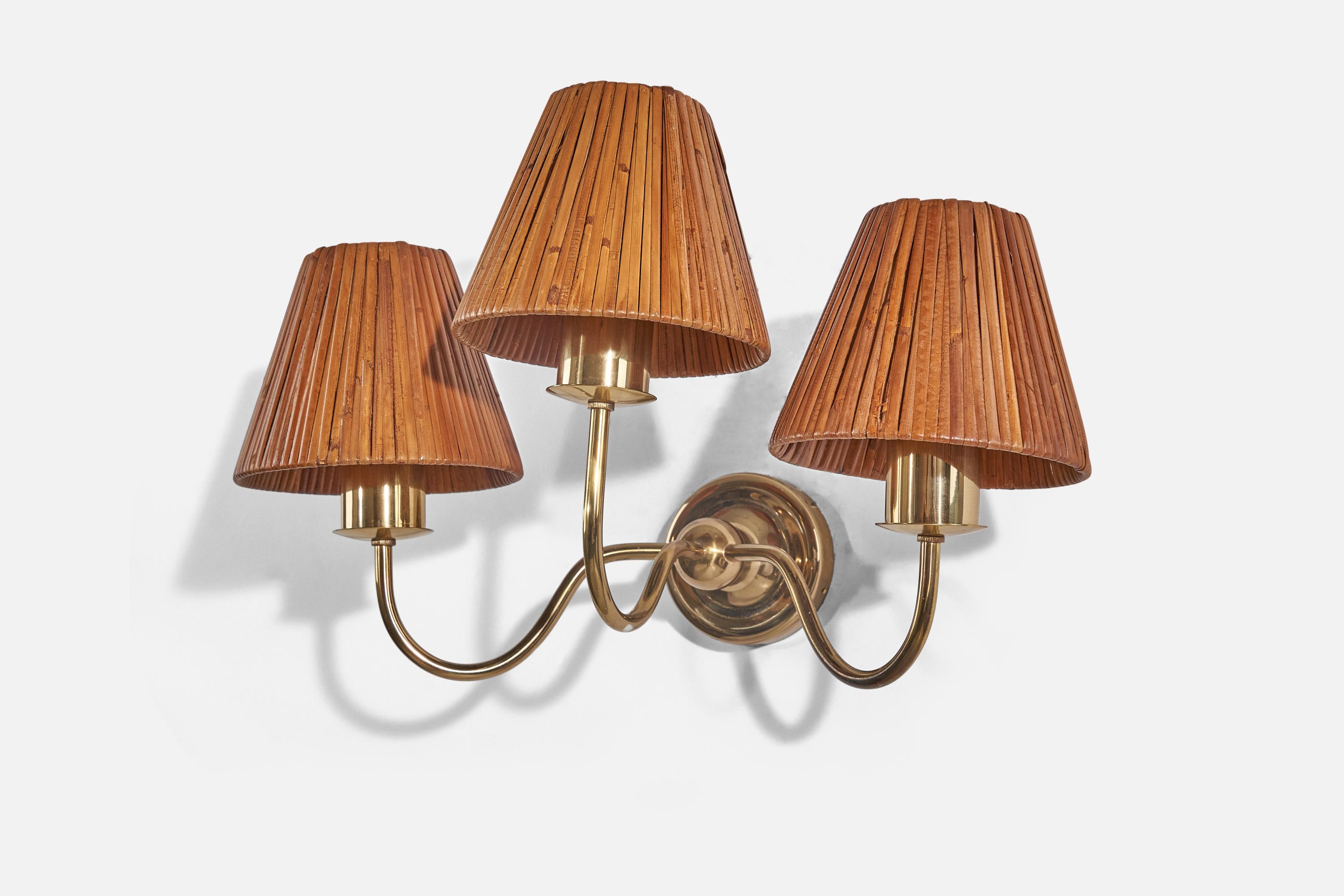 A brass and rattan wall light designed and produced by Josef Frank, Sweden, 1950s. Model designed in the 1920s. 

Sold with Lampshade. 
Stated dimensions refer to the Sconce with the shade. 
Dimensions of back plate (inches): 3.75 x 3.75 x 0.87