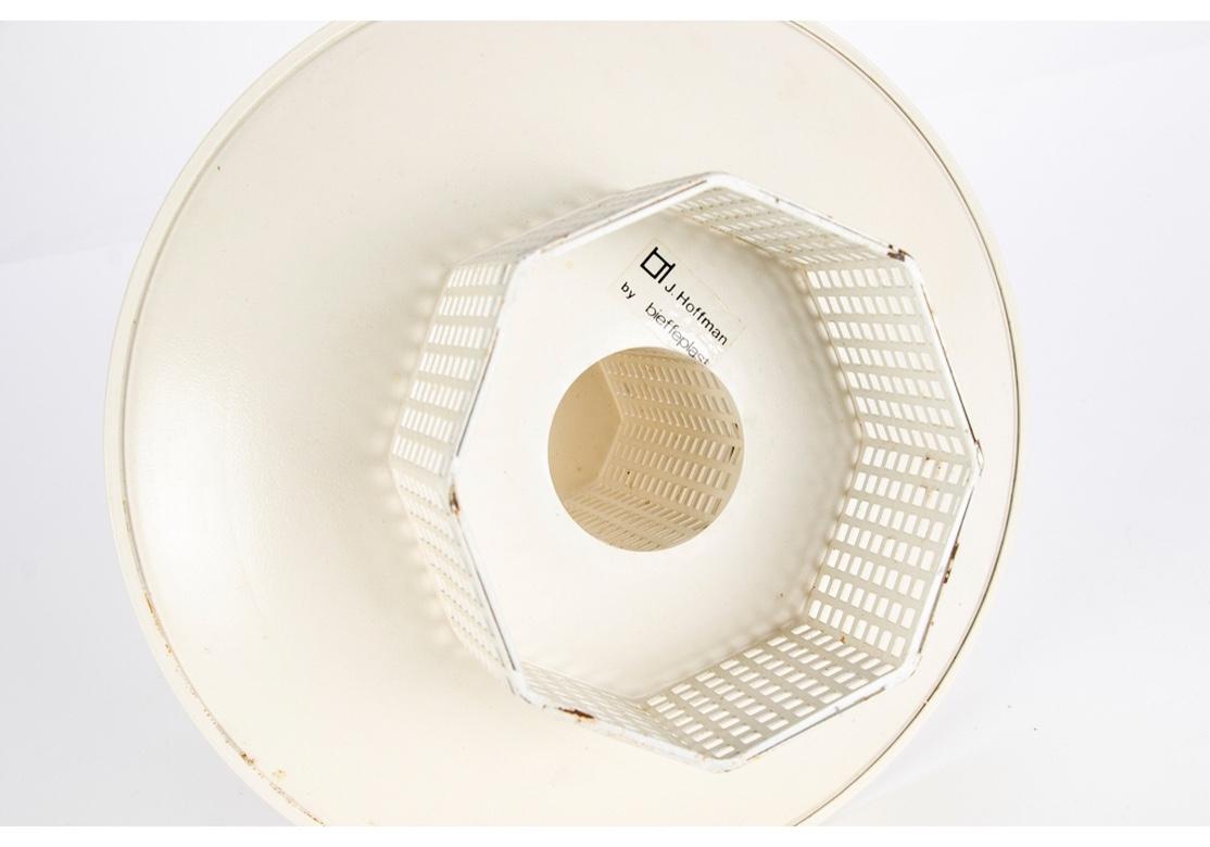 A classic Hoffman design of ca. 1905 in pierced sheet metal reissued by Bieffe Plast Italy in the 1960's. A white two tiered server with dishes mounted on an octagonal white enameled sheet metal support and matching base. 
Measures: Height 8 1/2