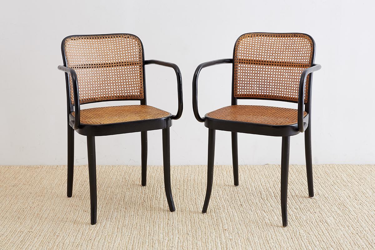 Pair of black 811 bentwood and cane Prague armchairs designed by Josef Hoffman for Stendig after Thonet. Sleek design from 1925 constructed from beechwood frames with hand-caned inserts. Imported by Stendig for Thonet. These chairs have a rare black