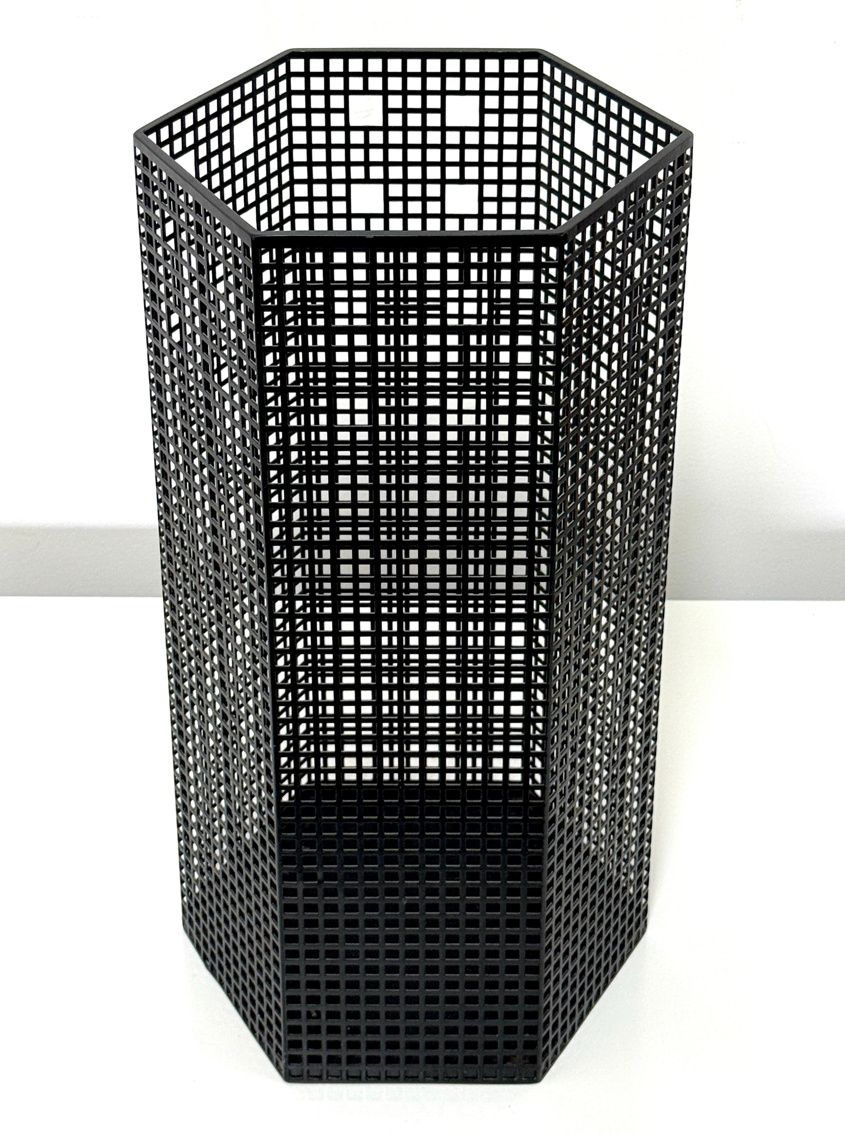 Josef Hoffmann hexagonal wastebasket or umbrella stand 
Originally designed in 1905, edition Bieffeplast circa 1980s

Gitterwerk structure in black perforated steel with original label intact to underside

10 inch diameter
19.125 inch height
 