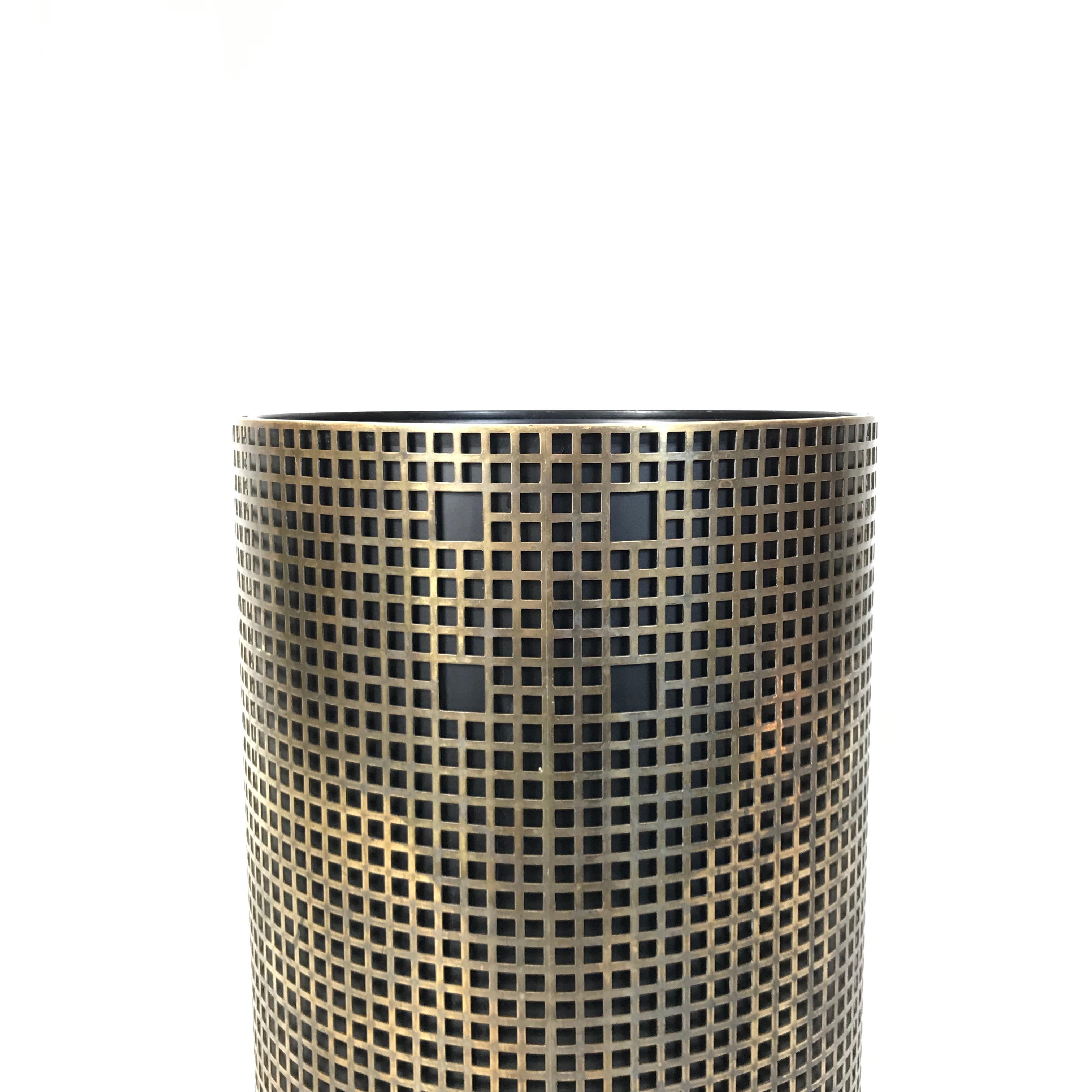 Simple and elegant umbrella stand in style of Josef Hoffmann. Made of perforated brass with lacquered metal basket. Very fine handwork without visible welds. The basket can also be used as a plant pot.

Measures: Height 40 cm / 15.7 in.
Diameter