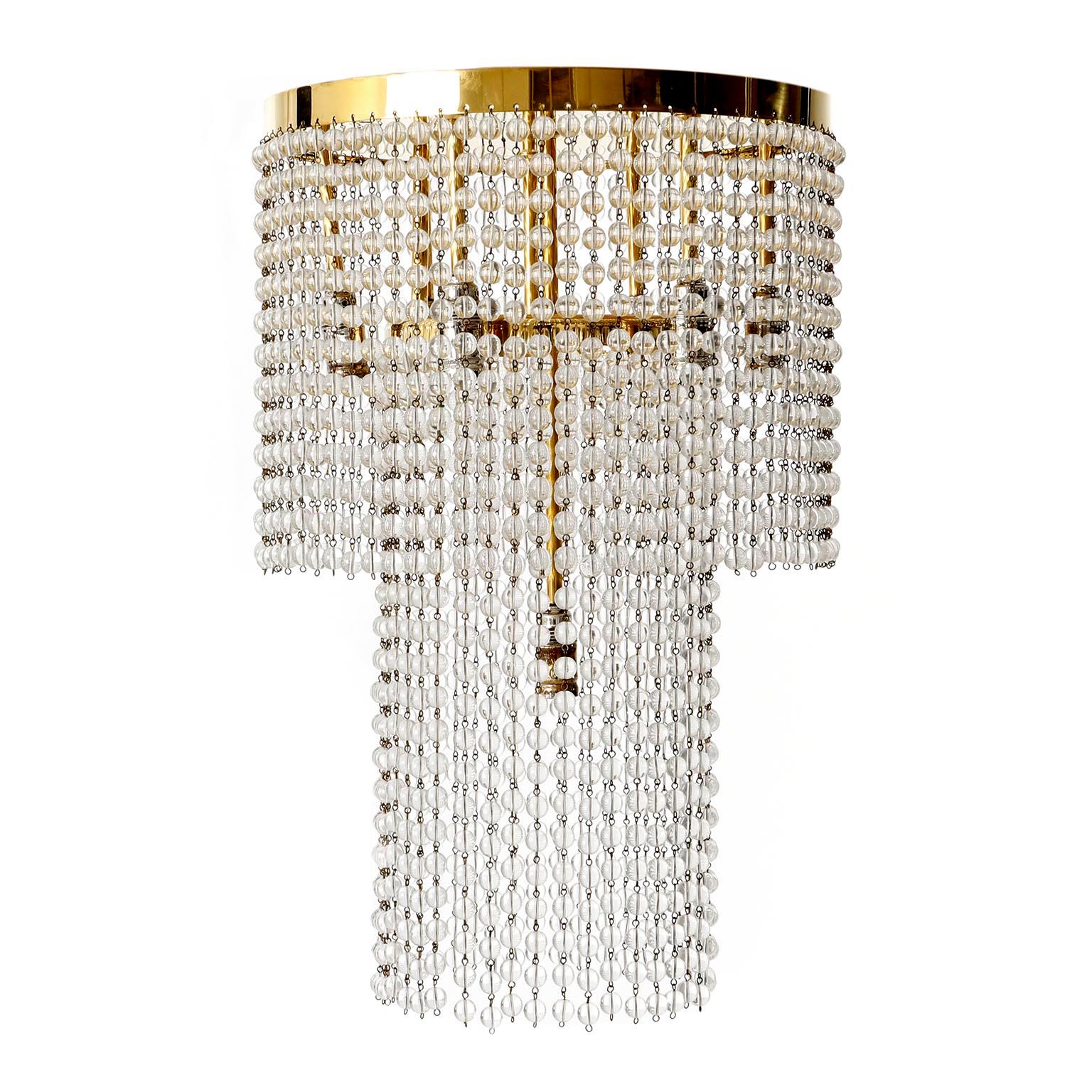 A flush mount chandelier which was used by Josef Hoffmann in the Hohe Warte buildings Brauner and Hochstaetter in 1905-1907 as well as in the Salon Beer-Hofmann in 1905/06.
The light is made of brass and two tiers of crystal glass chains. Hundreds