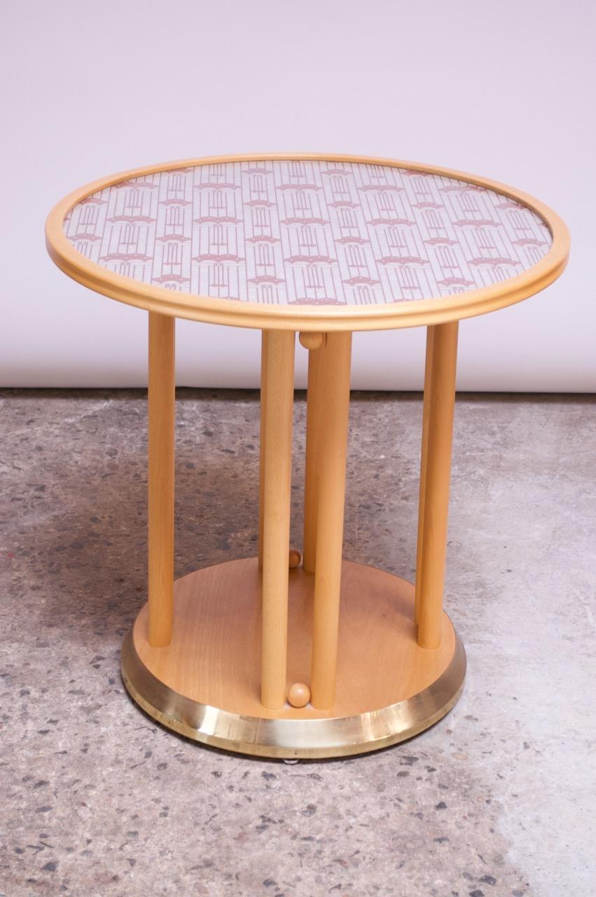 Impressive accent table originally designed in 1907 by Josef Hoffman for the Cabaret Fledermaus and manufactured in the 1960s by the Austrian manufacturer, Wittmann. Features a spindle-constructed beechwood frame with a brass-lined base and glass