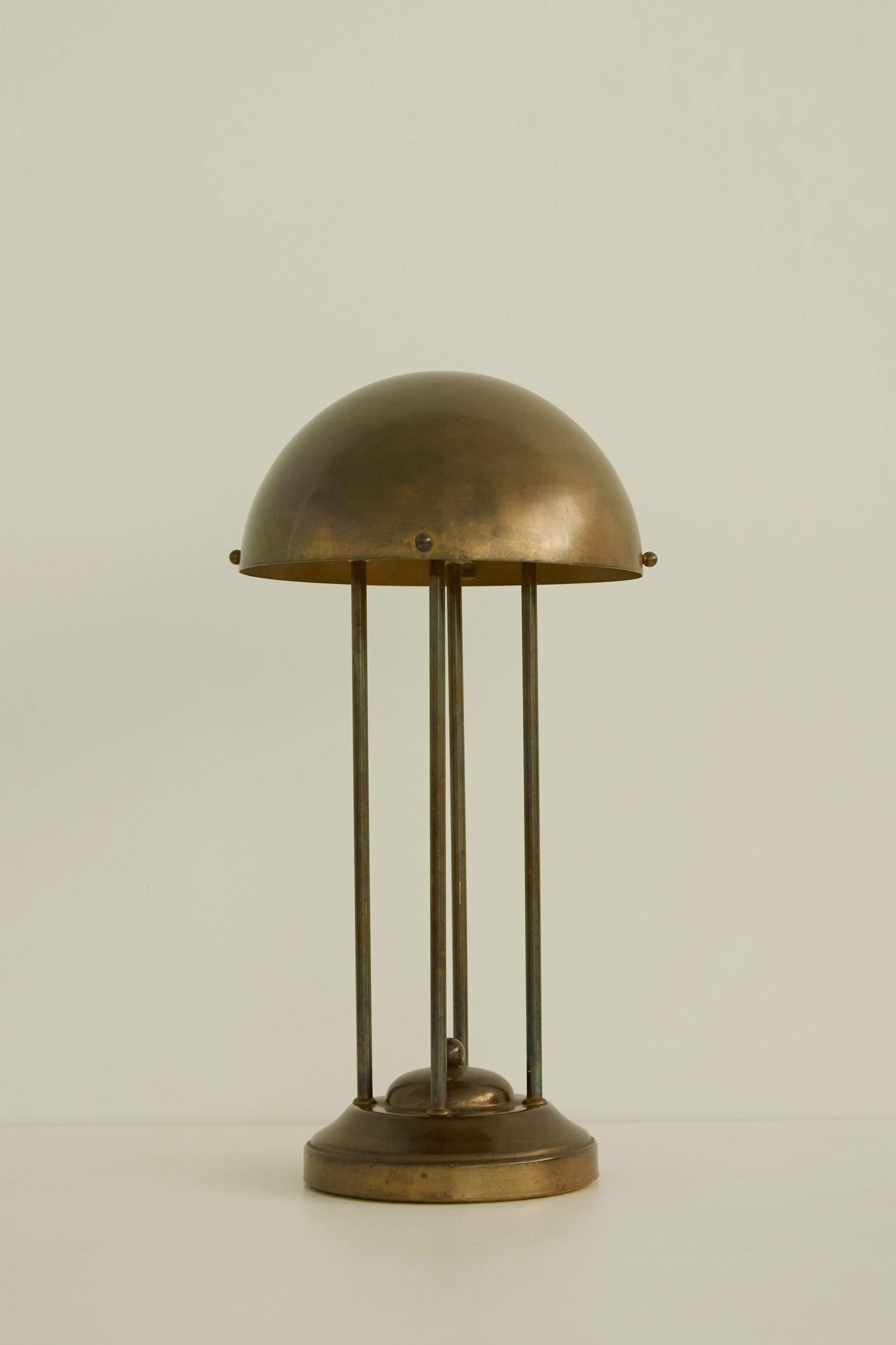 An elegant brass table lamp by Austrian designer Josef Hoffman. Its original design dates to 1900 but this piece is most likely a contemporary edition and later production circa 1965. The lamp features a wonderful patina throughout, its shade is