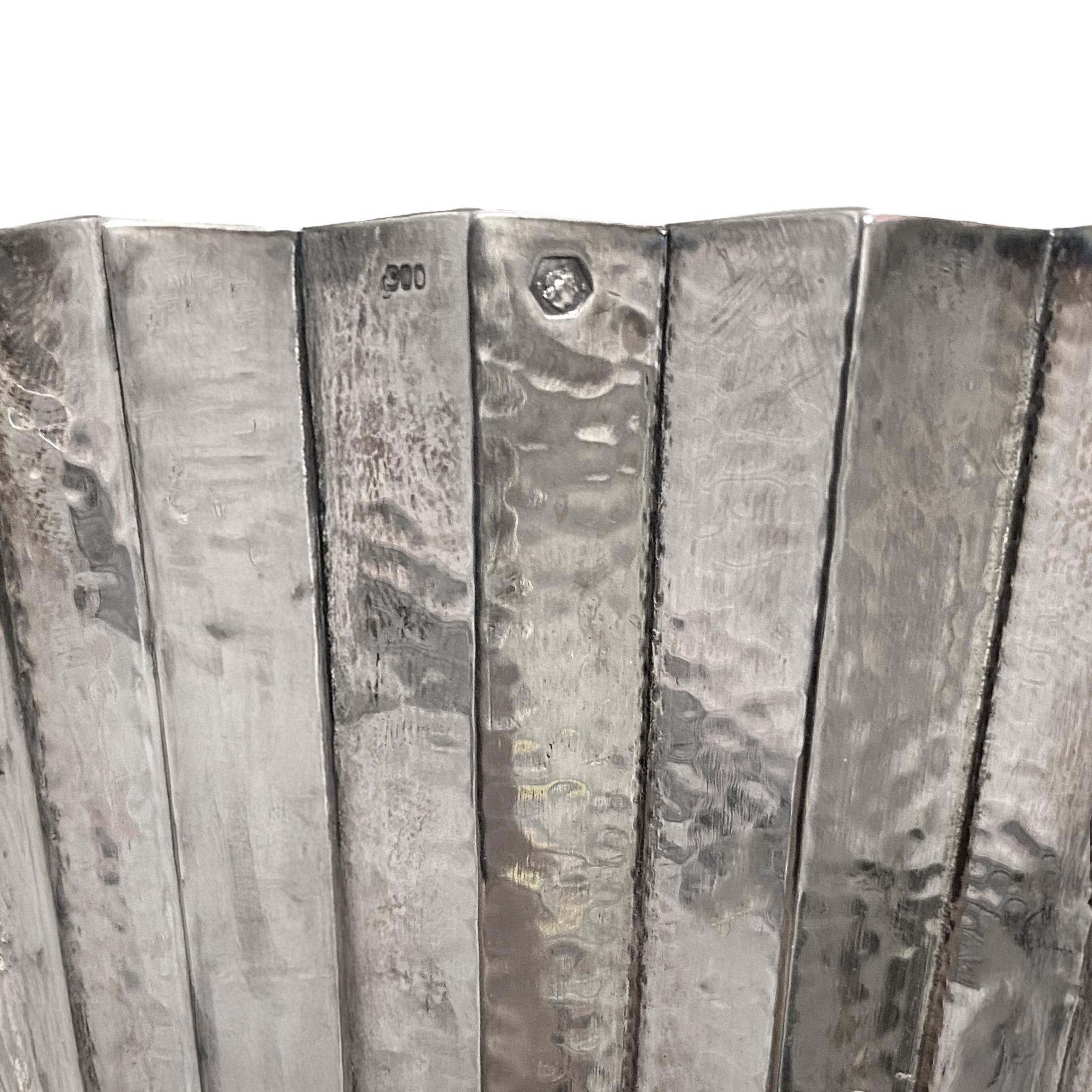 Hoffmann encountered an abundance of classical forms during his studies in Rome in 1896, which influenced his designs. The vases reference both the elegant form of a folding fan and the 19th-century invention of corrugated galvanized iron—a cheap,
