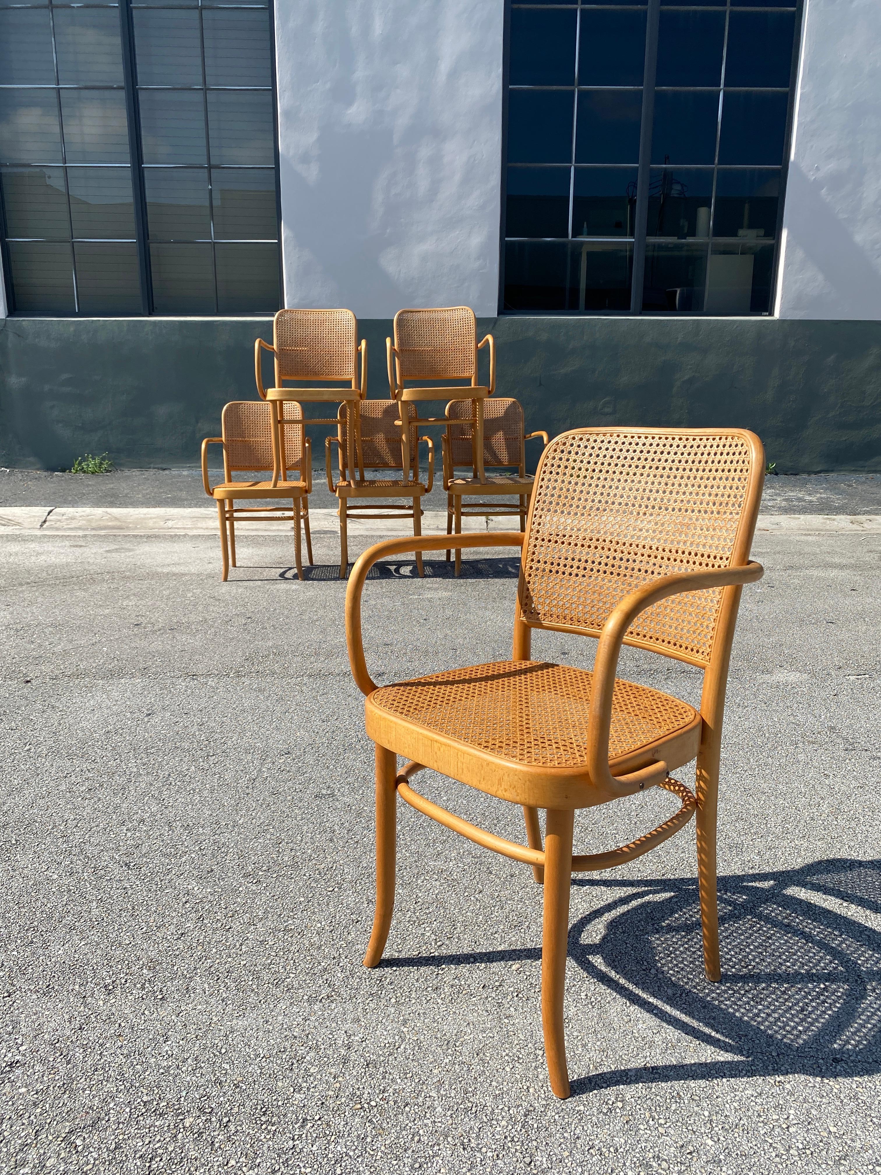 Mid-Century bentwood beech armchairs designed by Austrian architects Josef Frank and Josef Hoffman for Thonet. Each chair stamped made in Yugoslavia, feature cane inset seat and backs. Designed in the 1920s, these ‘Prague’ chairs model 811 have an