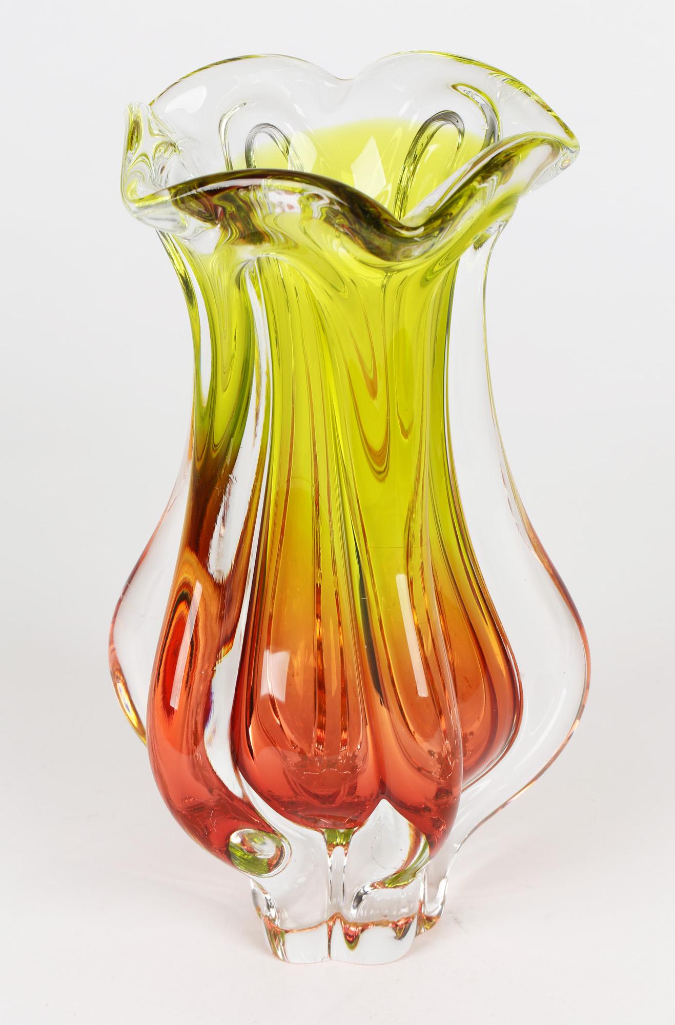 A stunning Czech Chribska art glass vase in yellow and red cased glass by Josef Hospodka and dating from around 1960. The heavily blown glass vase stands on a narrow shaped foot which has been ground flat and has five protruding handle like wings