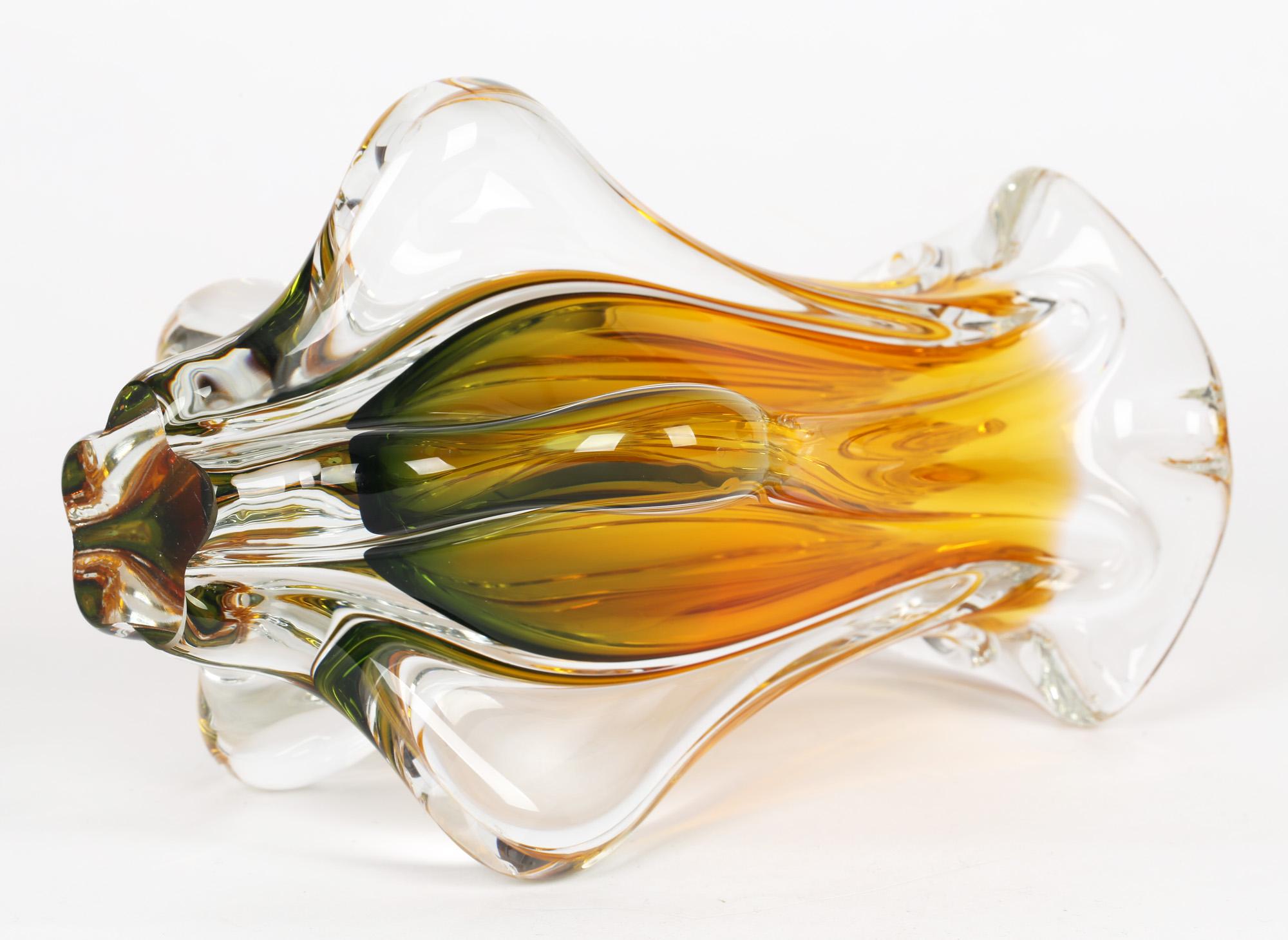 A stunning Czech Chibska art glass vase in yellow and green cased glass by Josef Hospodka and dating from around 1960. The heavily blown glass vase stands on a narrow shaped foot which has been ground flat and has five protruding handle like wings