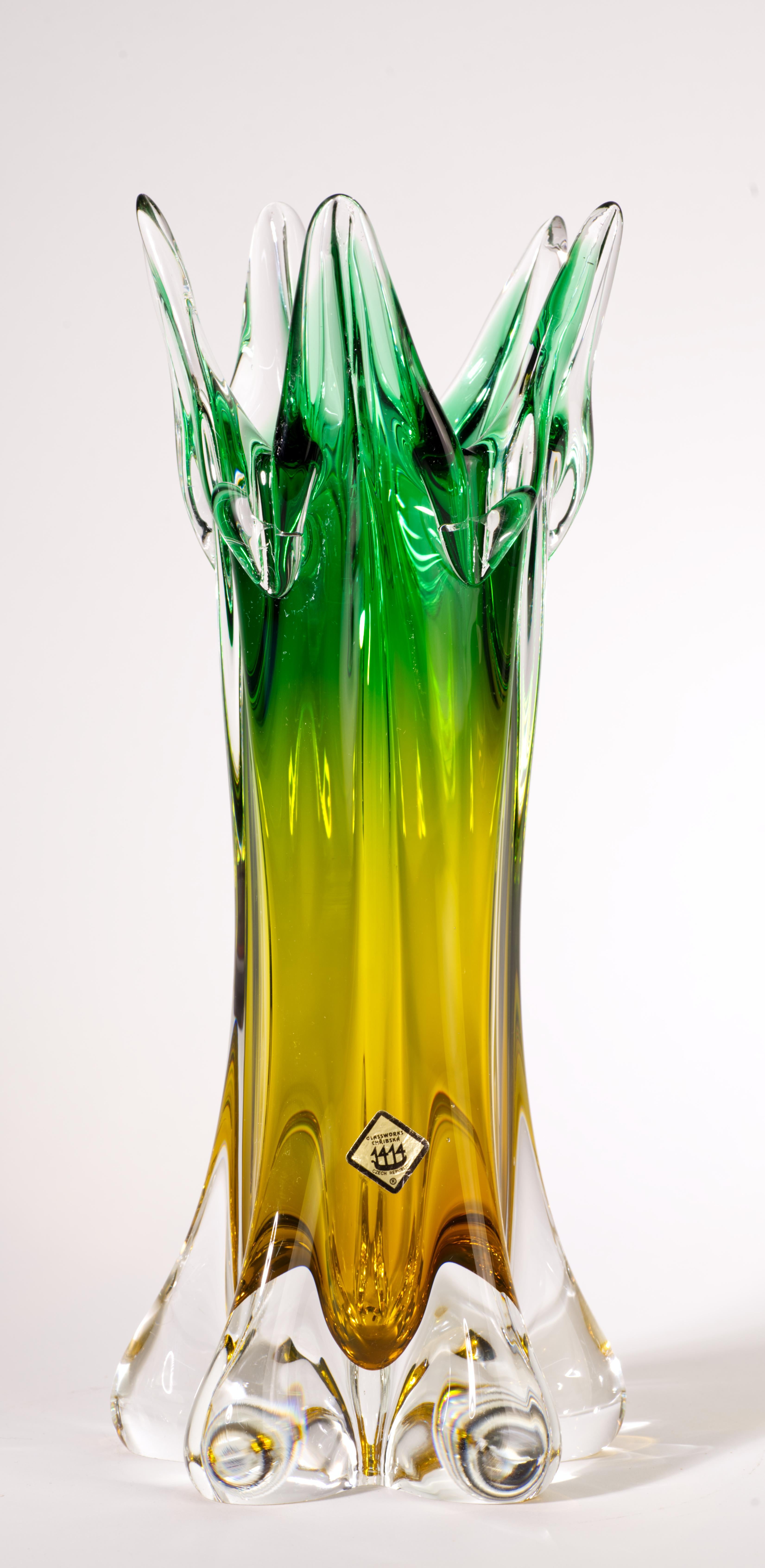  Striking sculptural vase with pulled and manipulated rim has ombre color shift from deep green on top third of the vase to amber; colored glass is encased in clear glass in sommerso technique, with clear glass base defining the composition. The