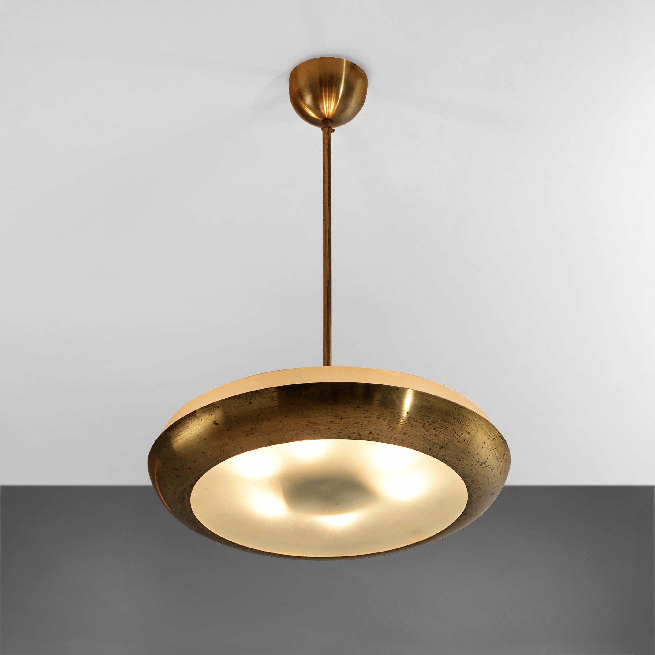 Josef Hurka for Napako, pendant, brass, metal, glass, Czech Republic, 1940s

Josef Hurka designed this pendant for Napako. The brass pendant has a bowl shaped shade. Structured glass allows the view on six lightbulbs. The brass frame is joined by
