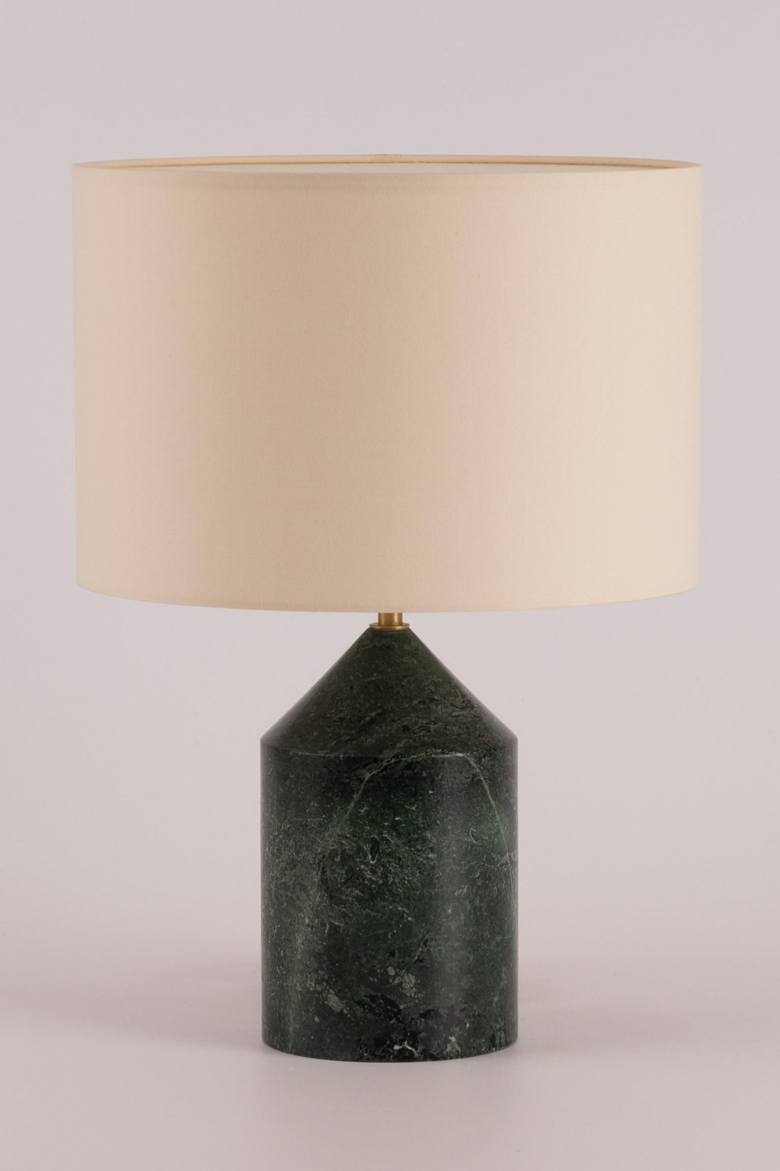 The Josef table merges cylinder and conical shapes on top of where sits a unique cotton drum lampshade, difusing a soft light. A perfect nightstand table lamp available in various finishes and colours (stone, ceramic and wood)