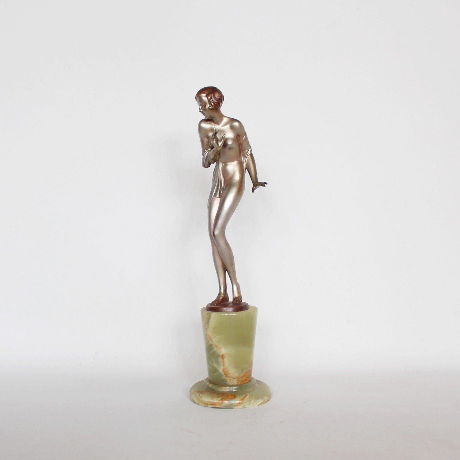 Scarf dancer, an Art Deco, cold painted bronze figure. Depicts a young lady draped elegantly in a scarf, set over a green onyx plinth.

Inscribed J Lor Bronze to bronze.


