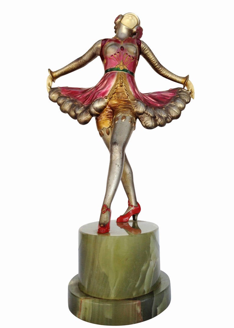 A superb spelter metal and Ivorine sculpture, this piece serves as a great example of early Art Deco statues made popular in the 1920s. The sculpture's style is reminiscent of similar styling popularized by metal sculptors like Josef Lorenzl.