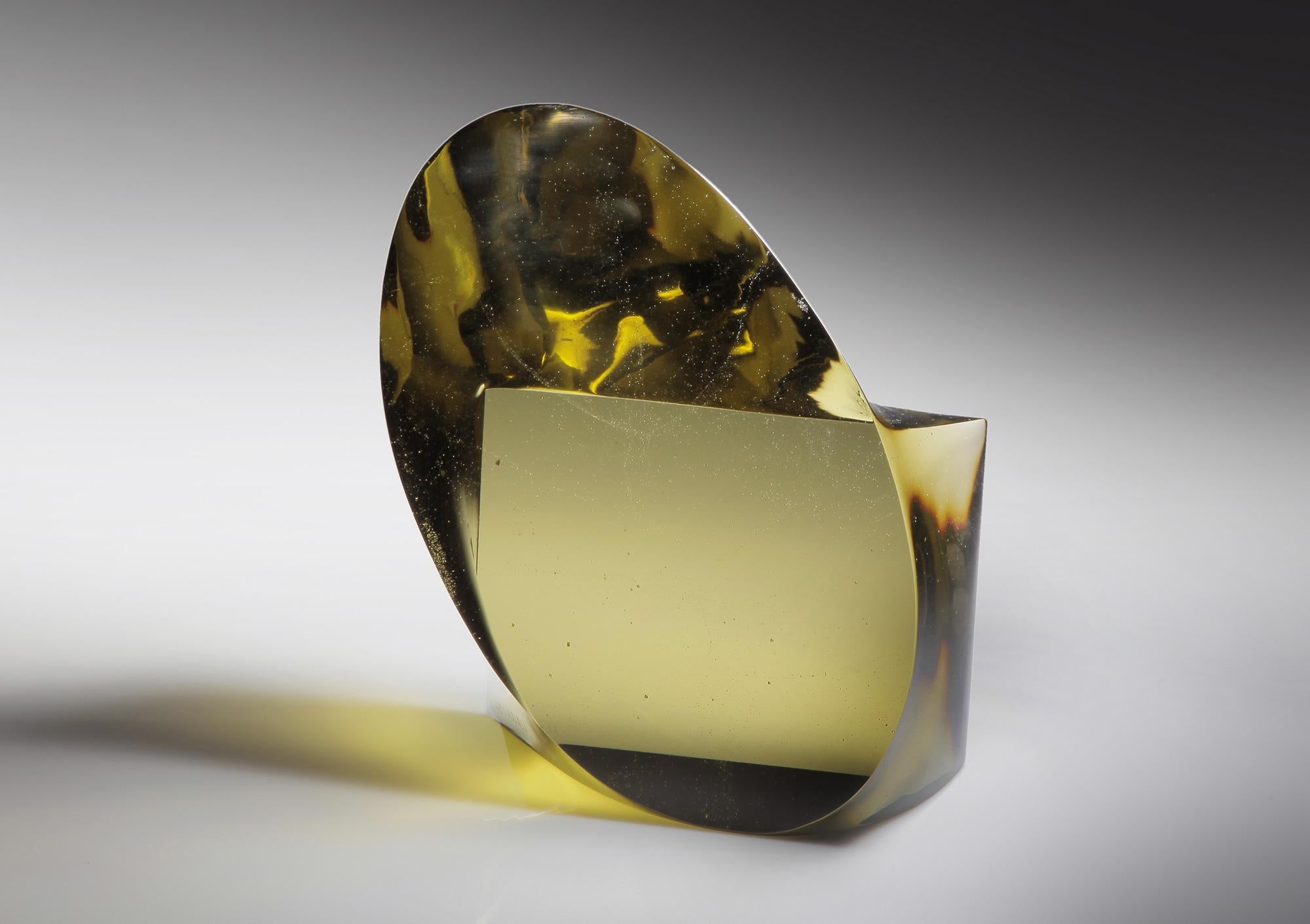 This cast glass sculpture in a vibrant, light chartreuse green color is like a window open to the rest of the universe! Minimalist in overall form, the smooth glass surfaces reveal an intriguing complexity to the rippling light and hidden geometry