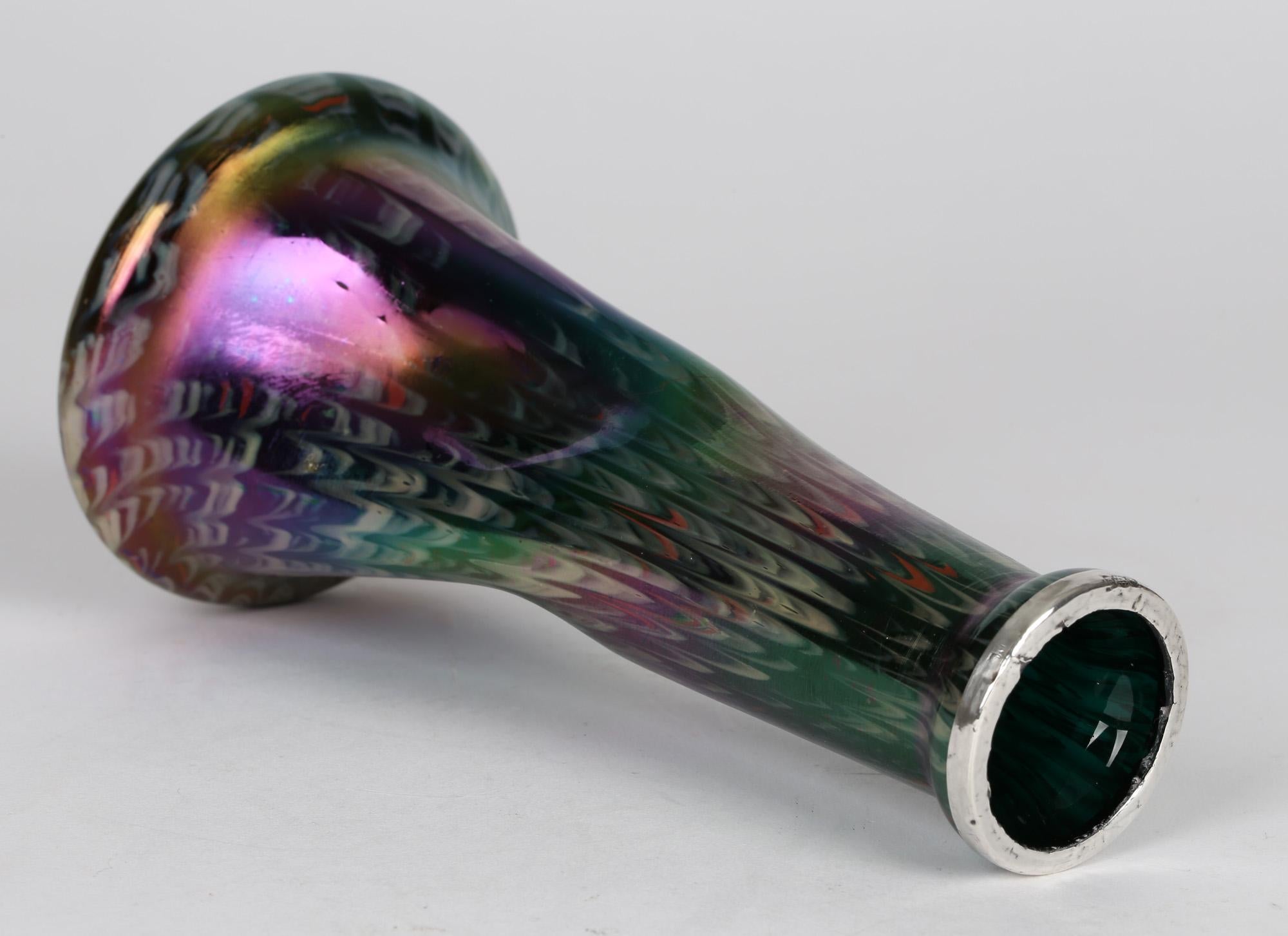A stunning Bohemian Art Nouveau art glass vase with an iridescent snake skin finish and silver rim by Josef Rindskopf and dating from around 1905. The vase has a wide rounded base and narrowing rounded body with a twist design to the body of the