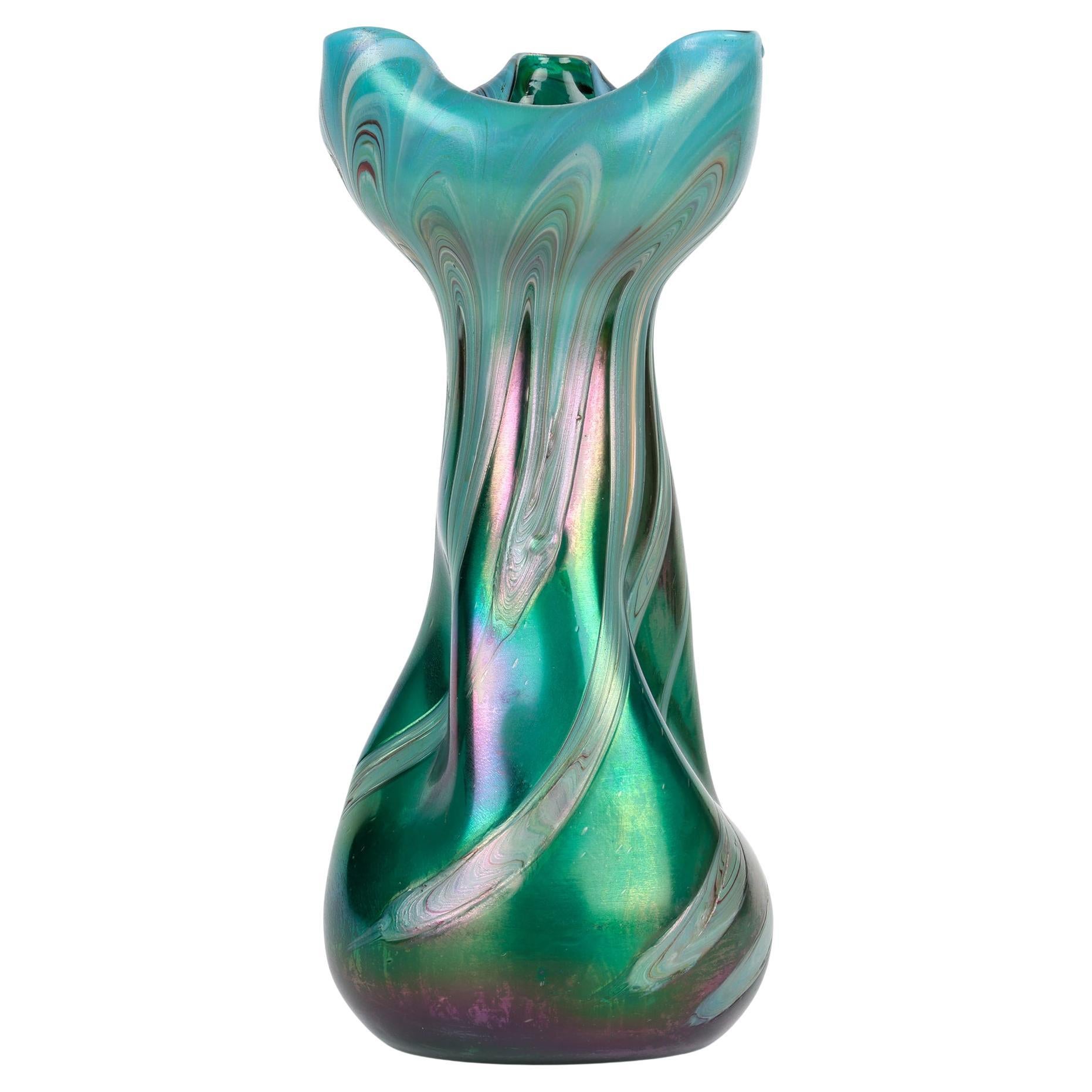 A large and impressive Boehmian Art Nouveau pulled feather iridescent art glass vase dating from around 1900. The tall hand-blown vase stands on a flat round base with a polished central pontil mark and has a tapering body with twist and pinched