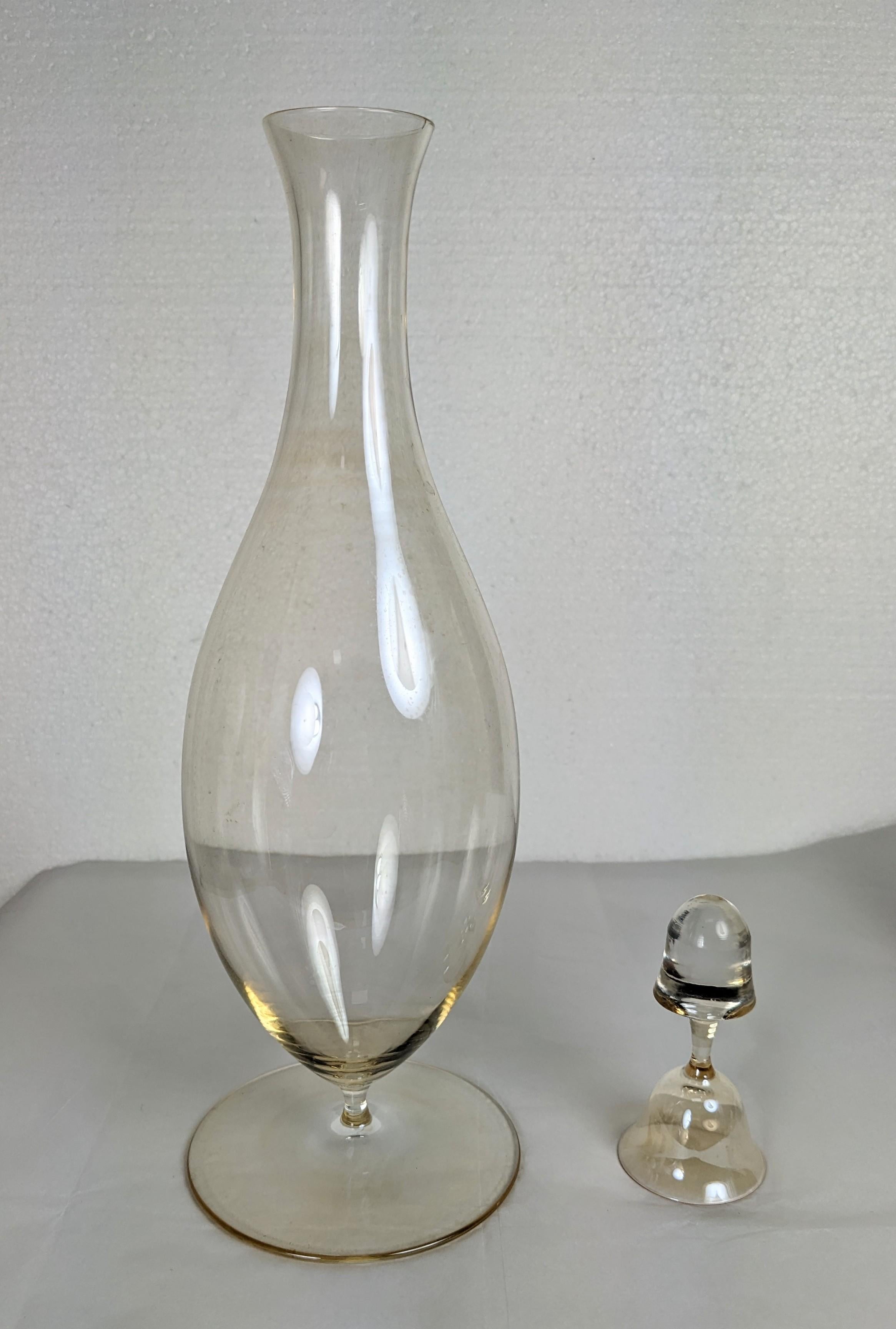 Joseff Hoffmann iconic decanter with drinking glass stopper for the Weiner Werkstatte. From the Patrician series by Lobmeyr. 1940's Austria. Slightly peach toned glass, not clear. 13.25 x 4