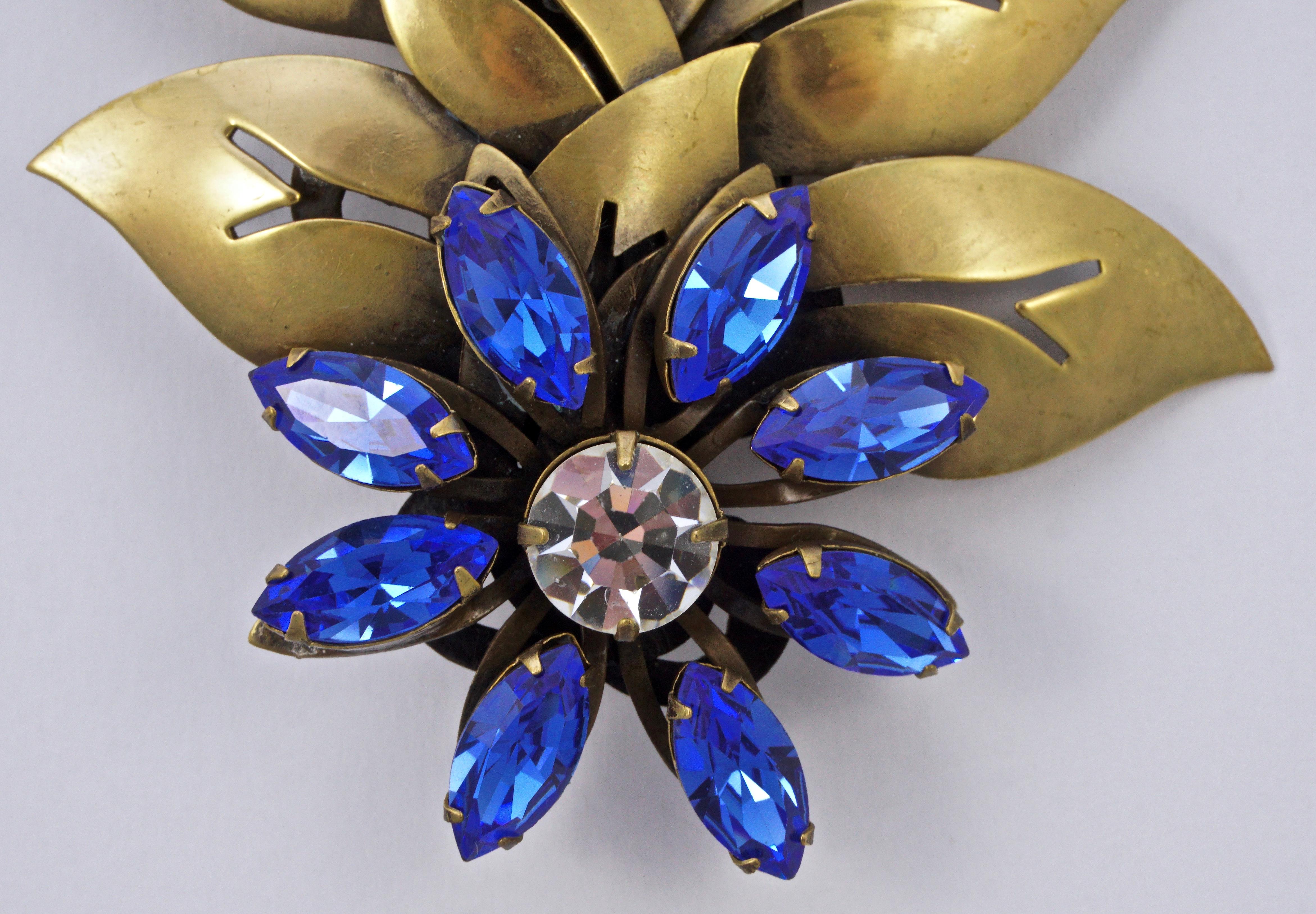 Fabulous Joseff of Hollywood gold plated large flower and cut out leaves brooch, and clip-on earrings set. Featuring dazzling cobalt blue marquise and round clear crystals. The brooch measures 11cm / 4.3 inches by 7.6cm / 3 inches, and the earrings