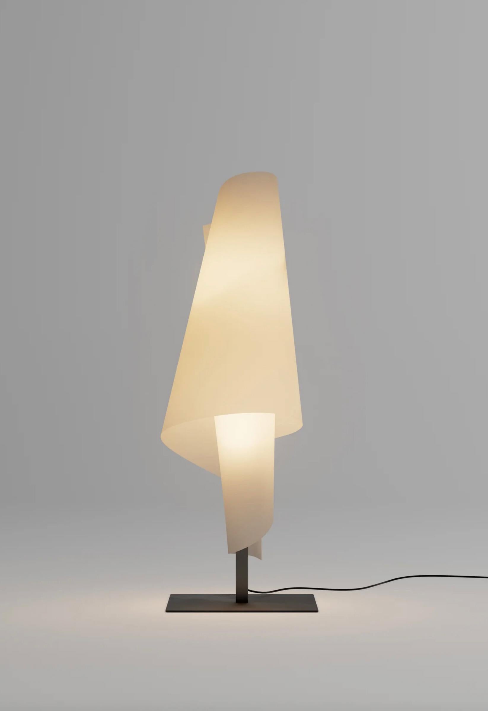 Josep Aregall  Talla 3 Table Lamp For Parachilna 
 
TALLA 3 is a lamp composed of a diffuser that wraps around a steel mast with a textured black finish. It maintains its shape thanks to the custom buttons gently screwed in the back of the lamp. The