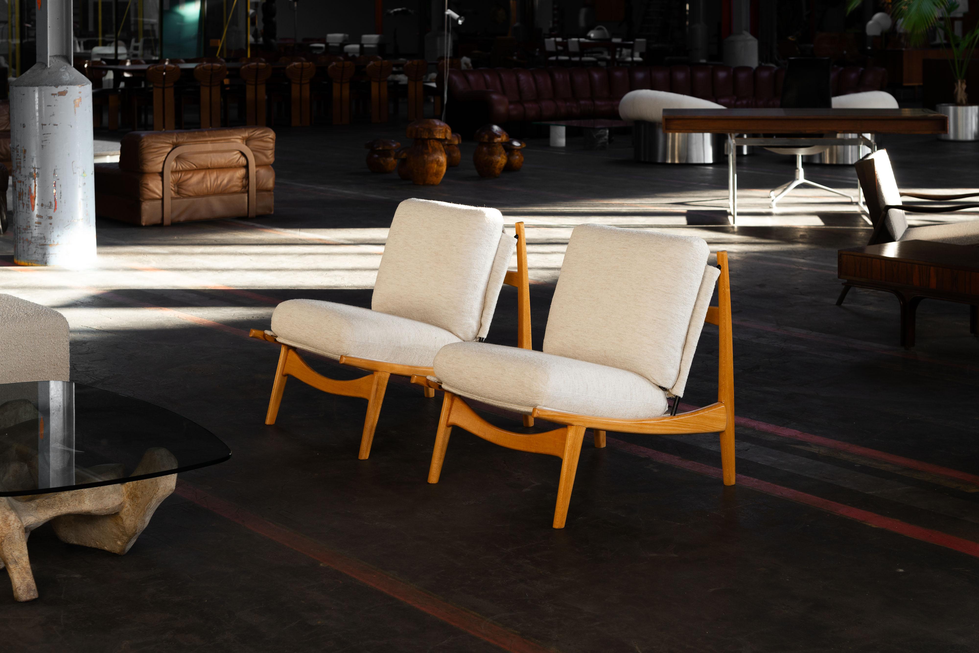 Sculptural pair of model 790 chairs designed by Joseph-André Motte and manufactured by Steiner, France 1960. These chairs have a cool boomerang-shaped structure made of solid blond beech wood. The frame is super simple but has awesome details. The