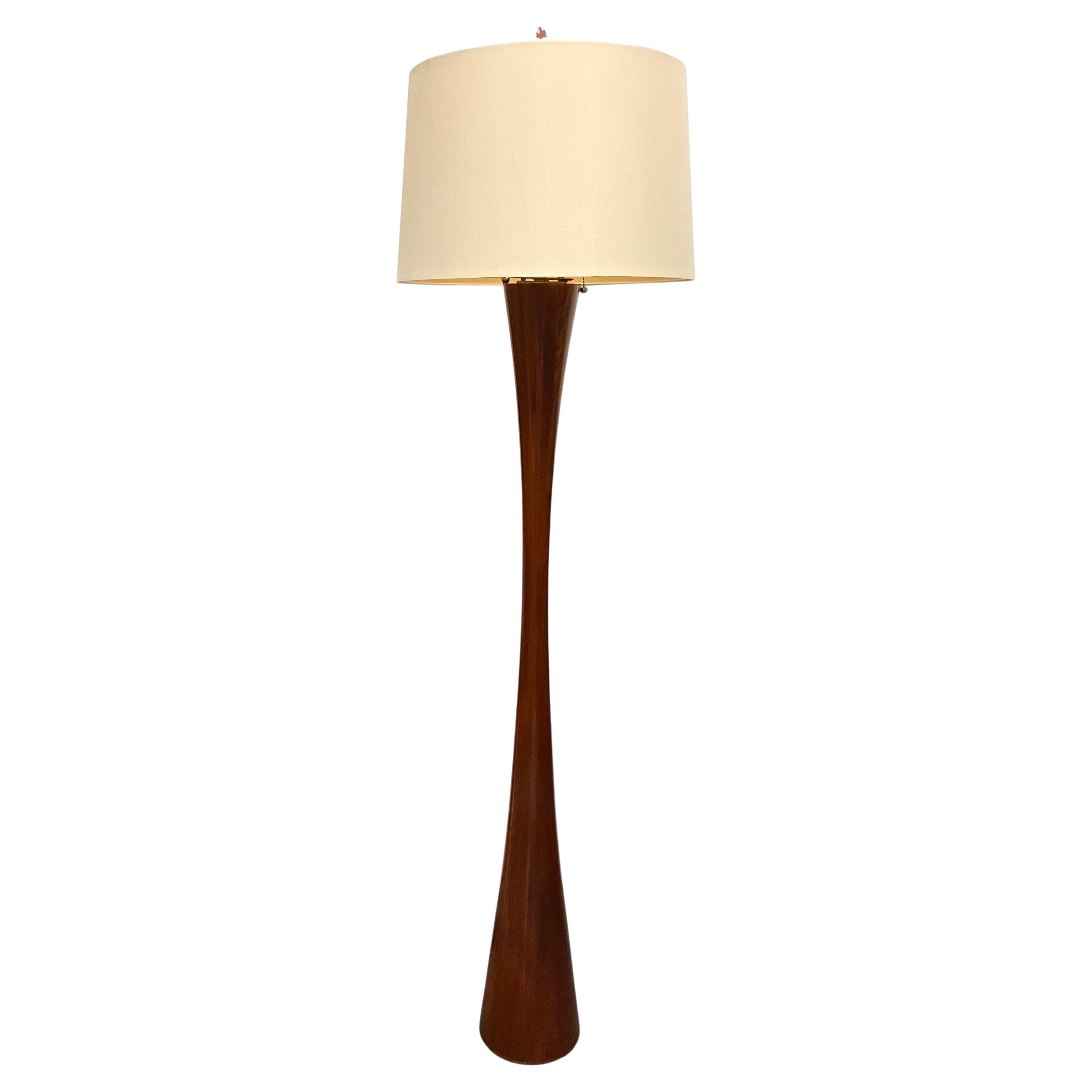 Solid staved mahogany in a sensual hourglass form. The J2 model was designed to accommodate a fabric shade. Produced and distributed by Disderot, Paris. Shade not included.