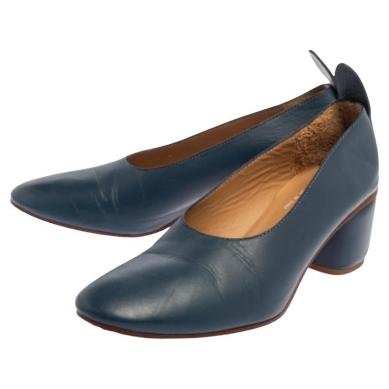 These pumps have been designed to accompany your style with ease! The shoes are a result of blending the comfort factor with minimal design elements. Crafted using blue-hued leather, the block-heeled pumps featuring round toes, extended counters,