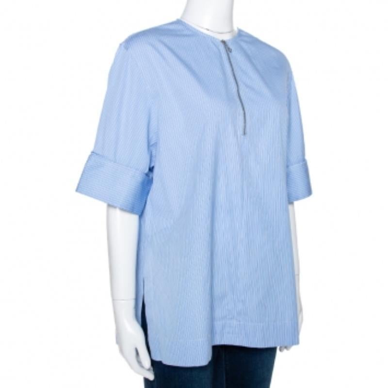 From the house of Joseph, style this blouse with subtle accessories and jeans for a casual look. Crafted from 100% cotton, it comes in a lovely shade of blue and features pinstripes that add interest. It is styled with a round neck, zip detail in