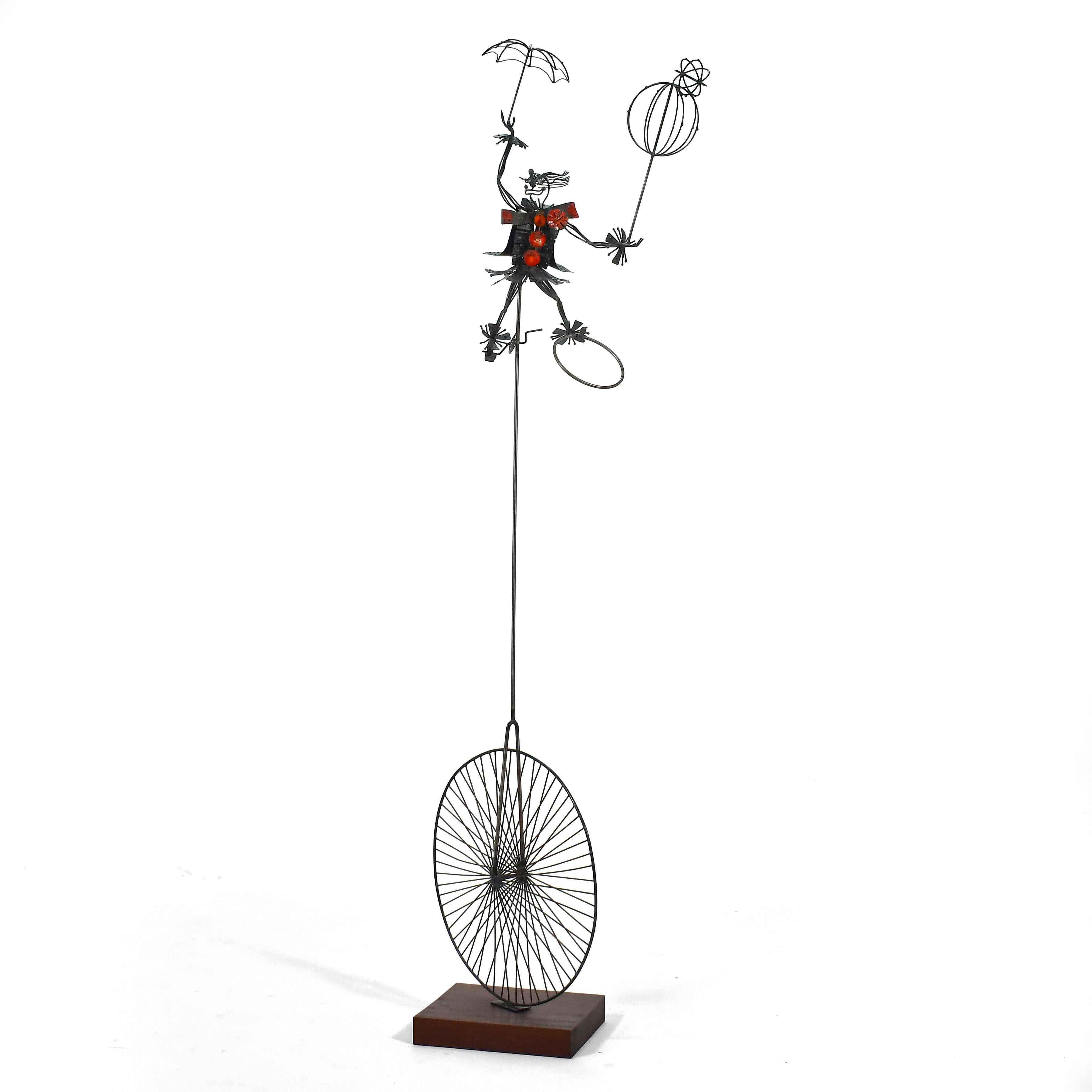 This delightful piece by Joseph A. Burlini (b. 1937) made of welded and enameled bronze features a whimsical clown perched high atop a unicycle with colorful enamel highlights. The linear quality of the textured rods give it the appearance of a