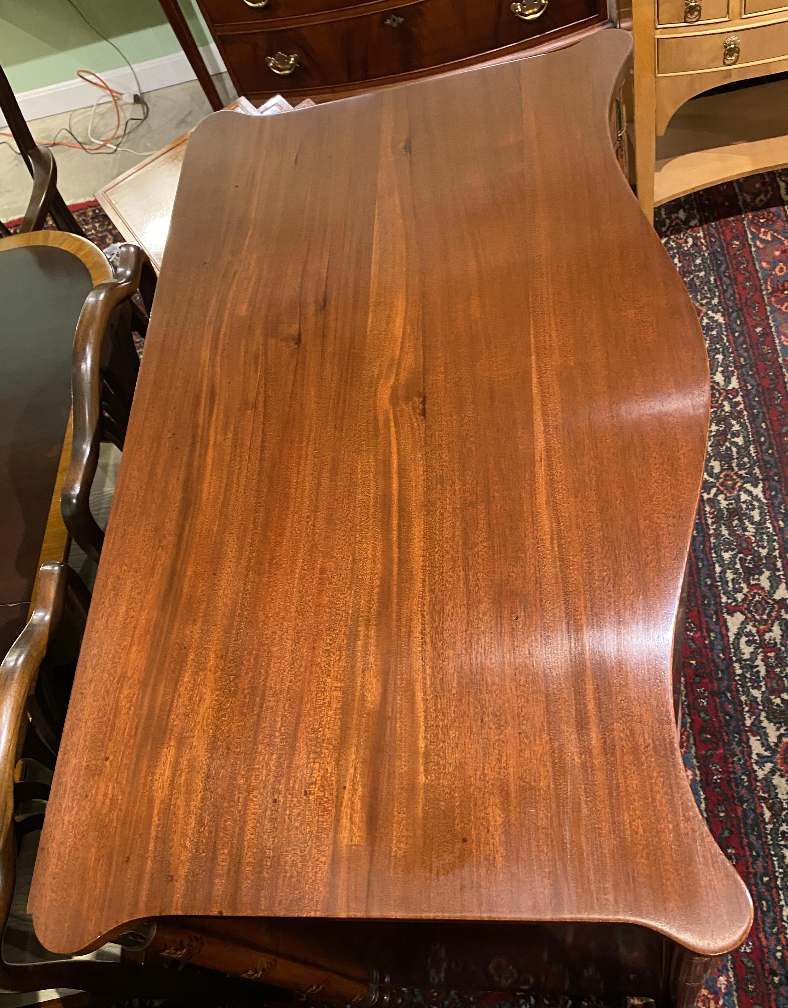 A beautiful mahogany and burled walnut serpentine cabinet or linen chest by Joseph Gerte, Boston, with conforming top, probably for linen storage, with hand painted oval paterae with classical figures and foliate decoration along its frieze drawer,