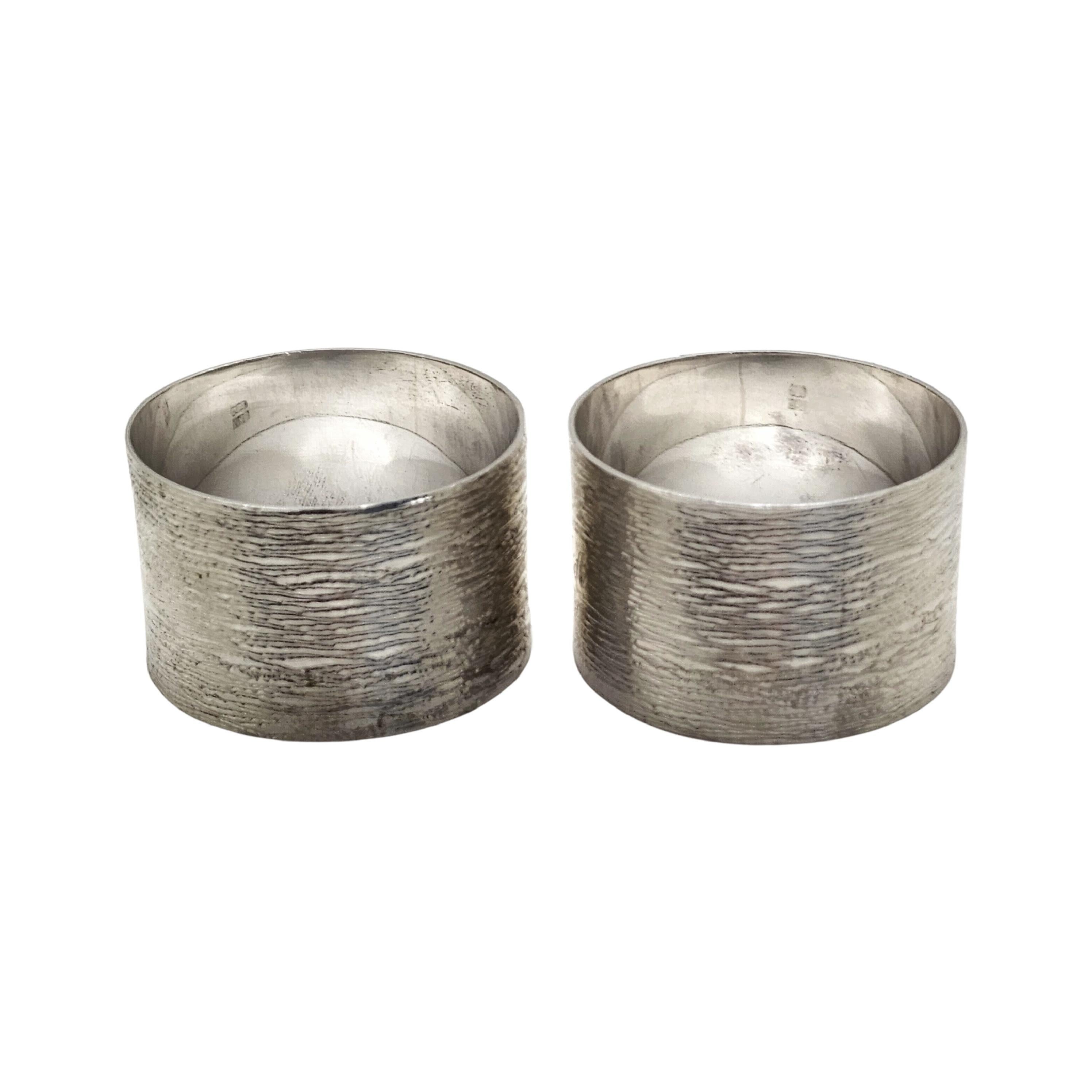 Set of 2 sterling silver napkins rings by Joseph Gloster of Birmingham, England, circa 1973.

Each napkin ring has a different monogram, appears to be BA and MA

Textured design finish.

Measures approx 1 1/16