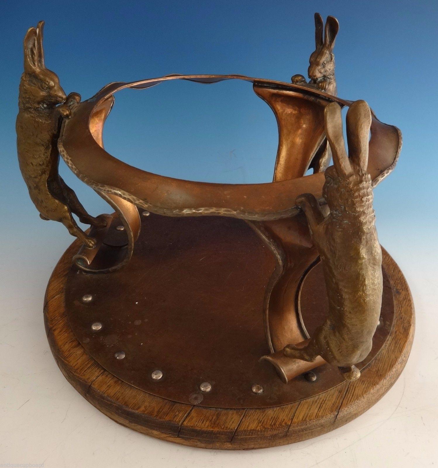 Joseph Heinrich

Arts & Crafts chafing dish made by Joseph Heinrichs featuring fabulous 3-D rabbits. The chaffing dish is made of copper with applied silver scrollwork on the wood handle and finial. It also includes the stand and burner. The piece