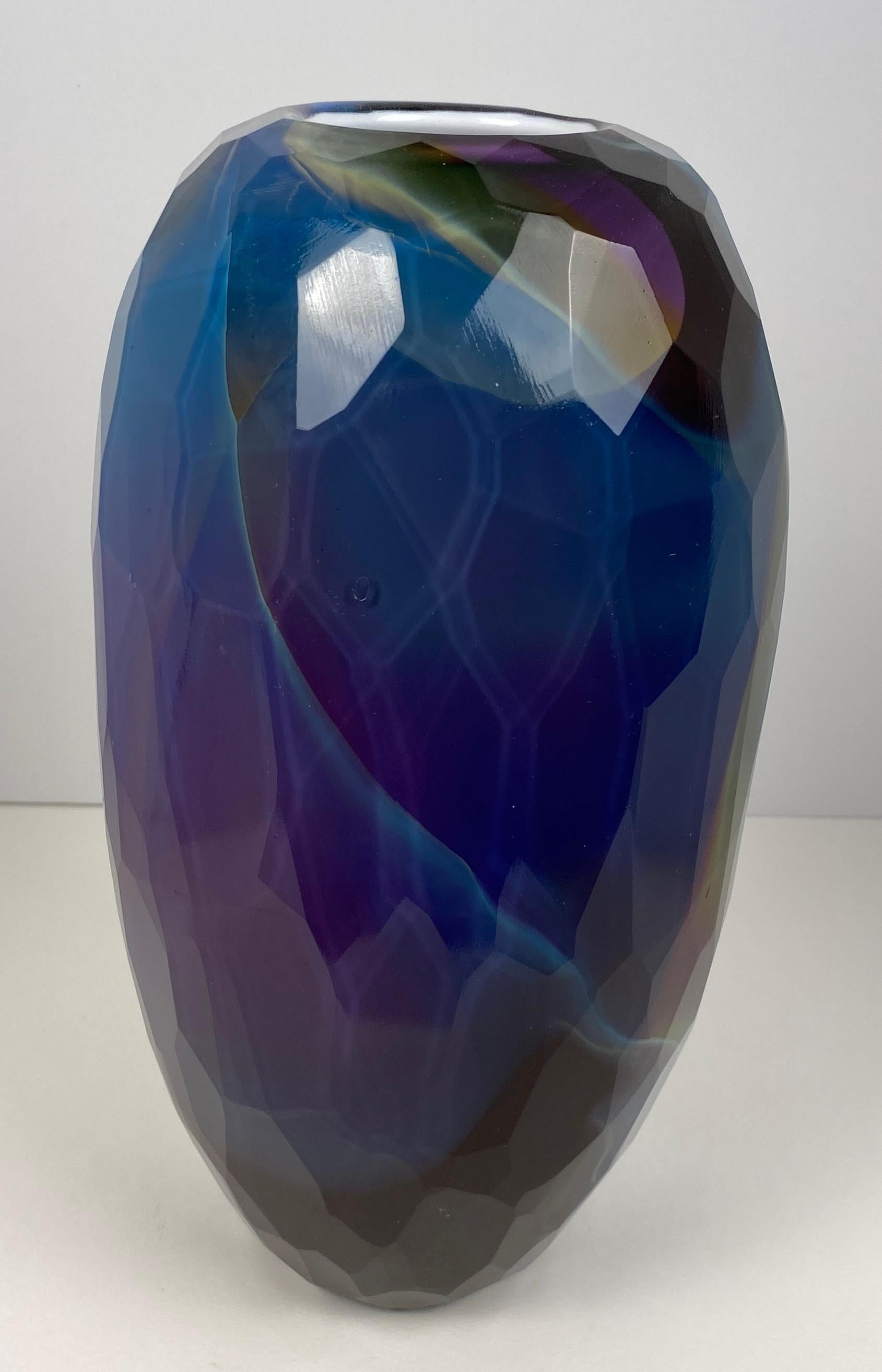 A very nice quality art glass flower vase by Joseph Hobbs. This lovely hand crafted art glass vase is signed by the artist. Crafted with attention to detail, patterns of irregular sized shapes on variations of cobalt blue and aqua blue shades.

This