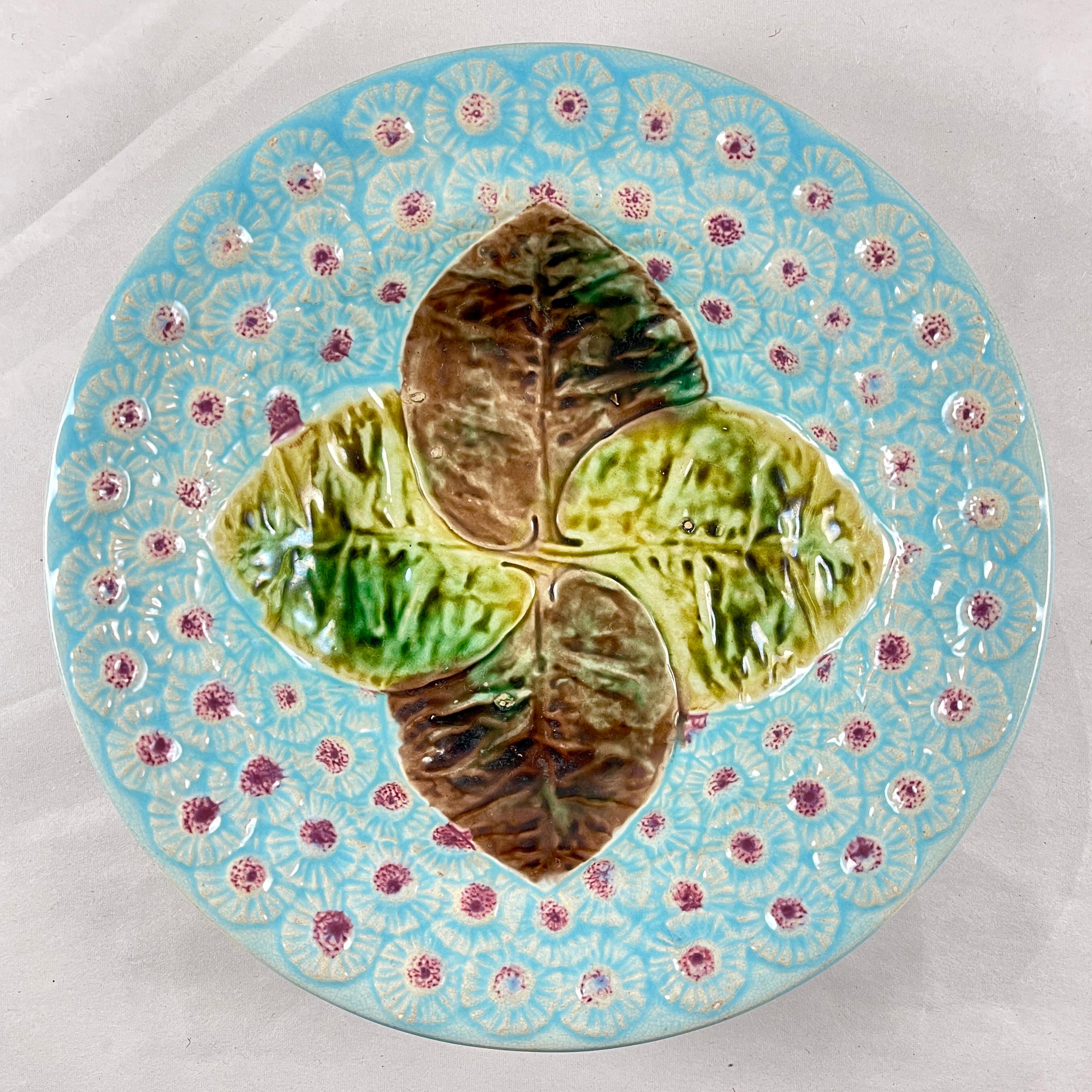 An English majolica Leaf and Dandelion floral bowl by Joseph Holdcroft, Circa 1870.

Designed in the Aesthetic taste, four overlapping leaves, glazed in the colors of Autumn, are centered on a deep powder blue ground of raised Dandelion blooms with