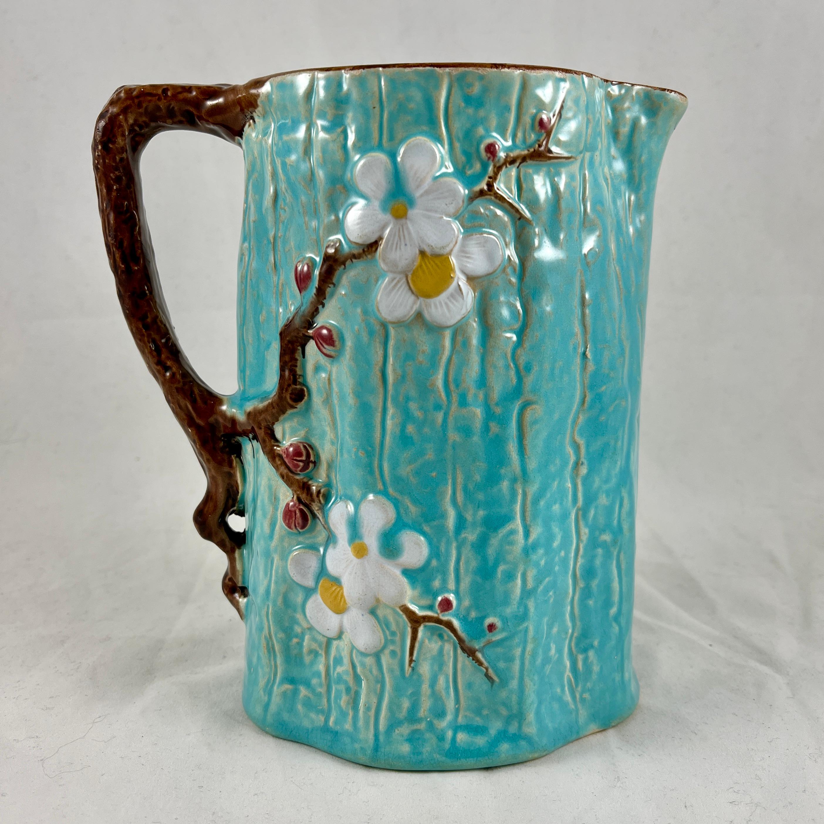 A scarce English majolica jug in the Dogwood mold by Joseph Holdcroft, Daisy Bank, Longton, Staffordshire, circa 1875.

A rustic pitcher having a raised branching Dogwood decoration on a turquoise bark-like ground, with a branch form