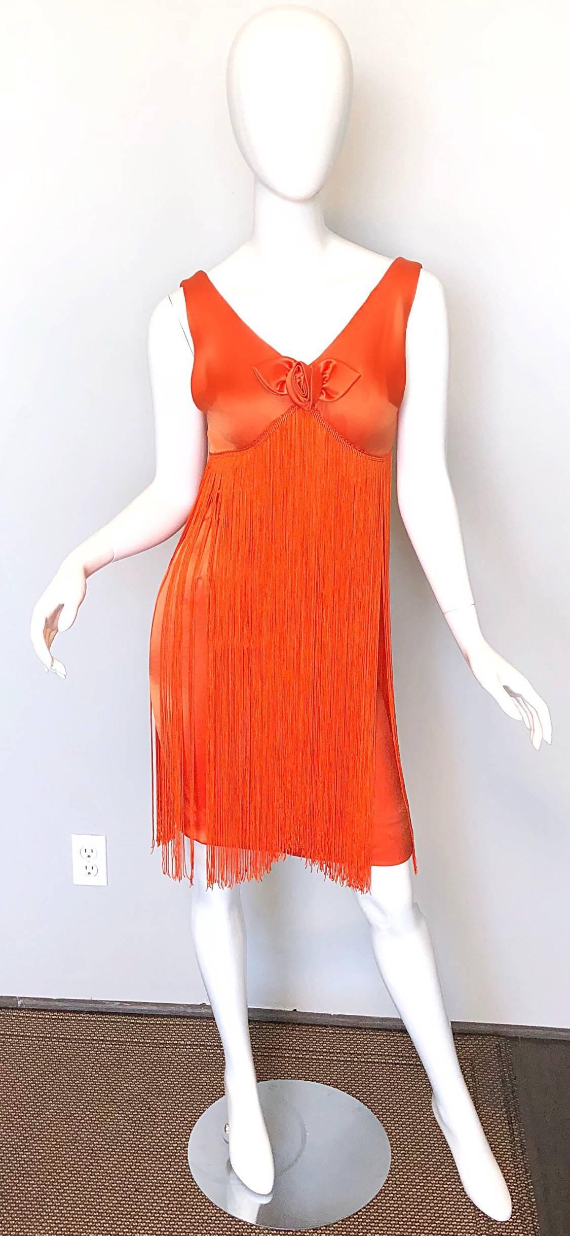 Amazing 1960s JOSEPH MAGNIN bright neon orange fully fringed dress! Features a bright orange jersey, with hundreds of hand sewn strings of long fringe under the front and back bodice. Hidden metal zipper up the back with hook-and-eye closure. Soft