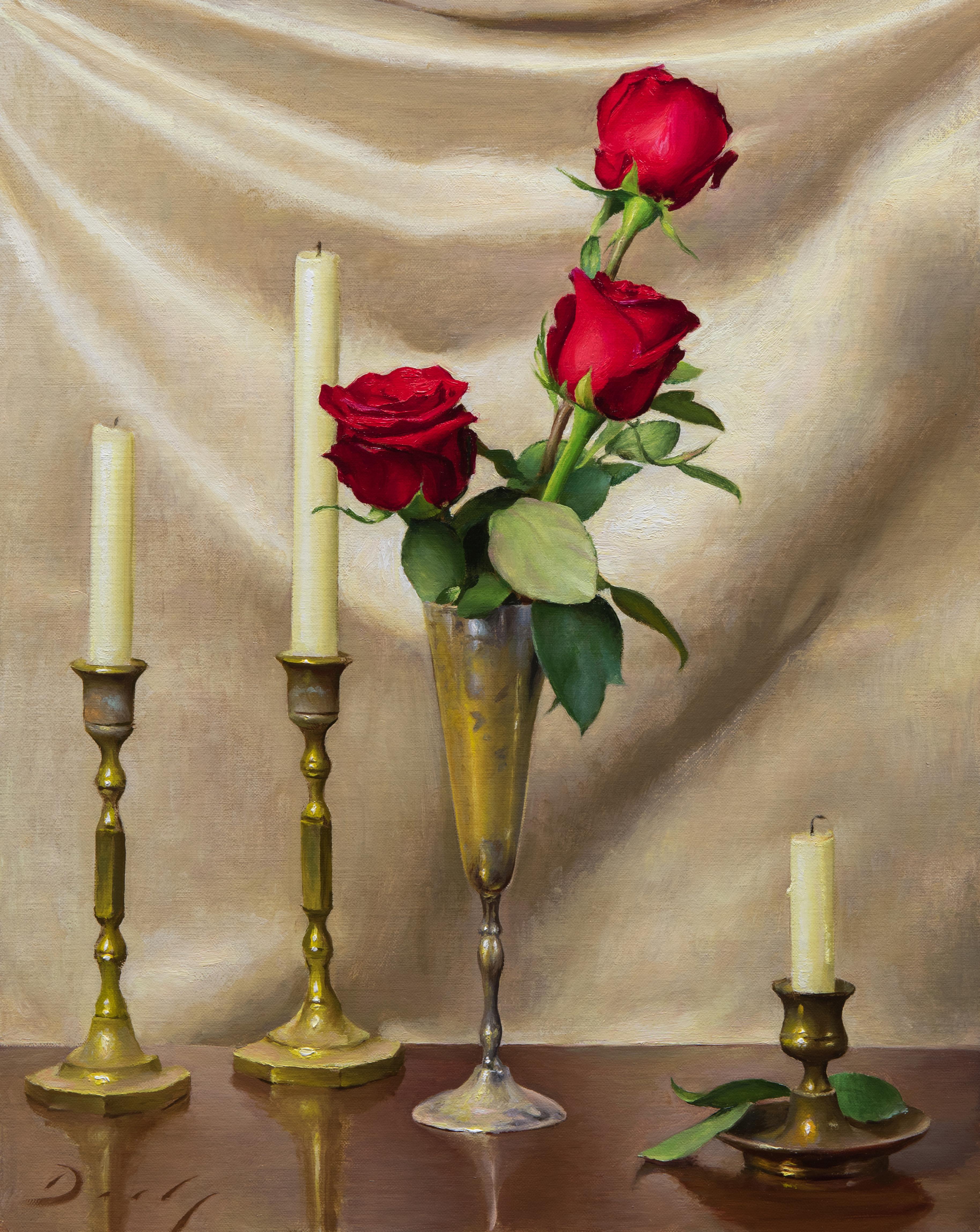 Arrangement in Red and Gold features three red roses in a delicate brass vase. Candlesticks flank both sides of the vase and their varying sizes provide interest to the otherwise simple composition. The light gold background does not detract from