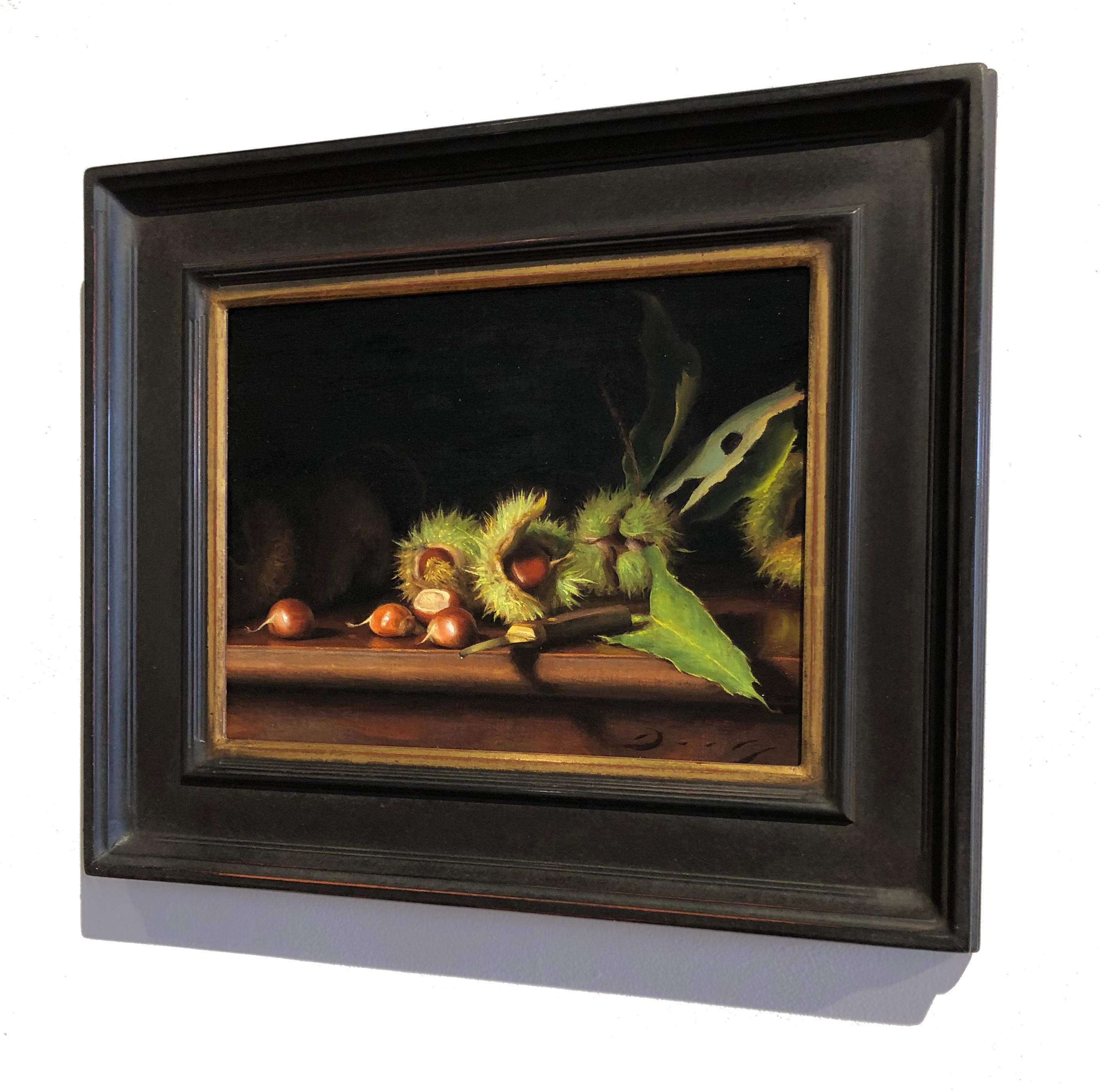 “Still Life with Freshly Fallen Chestnuts” is a realist oil on linen painting by Joseph Q. Daily. As the title suggests, the work depicts a still life scene with Chestnuts, some fallen and some still on the branch. Overall, the composition is dark