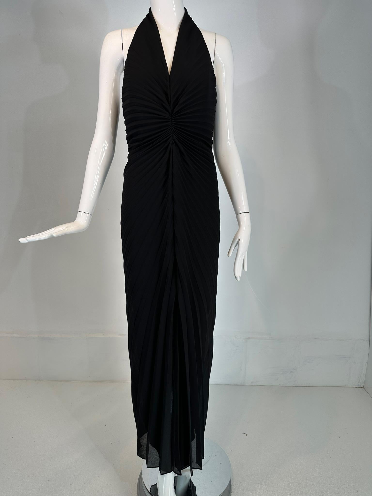 Joseph Ribkoff black crepe plunge V neckline sunburst pleat, halter neck dress from the 1990s. Black crepe stretch halter dress with a deep V plunge neckline. The dress is similar in style to the gold sunburst gown worn by Marilyn Monroe, designed