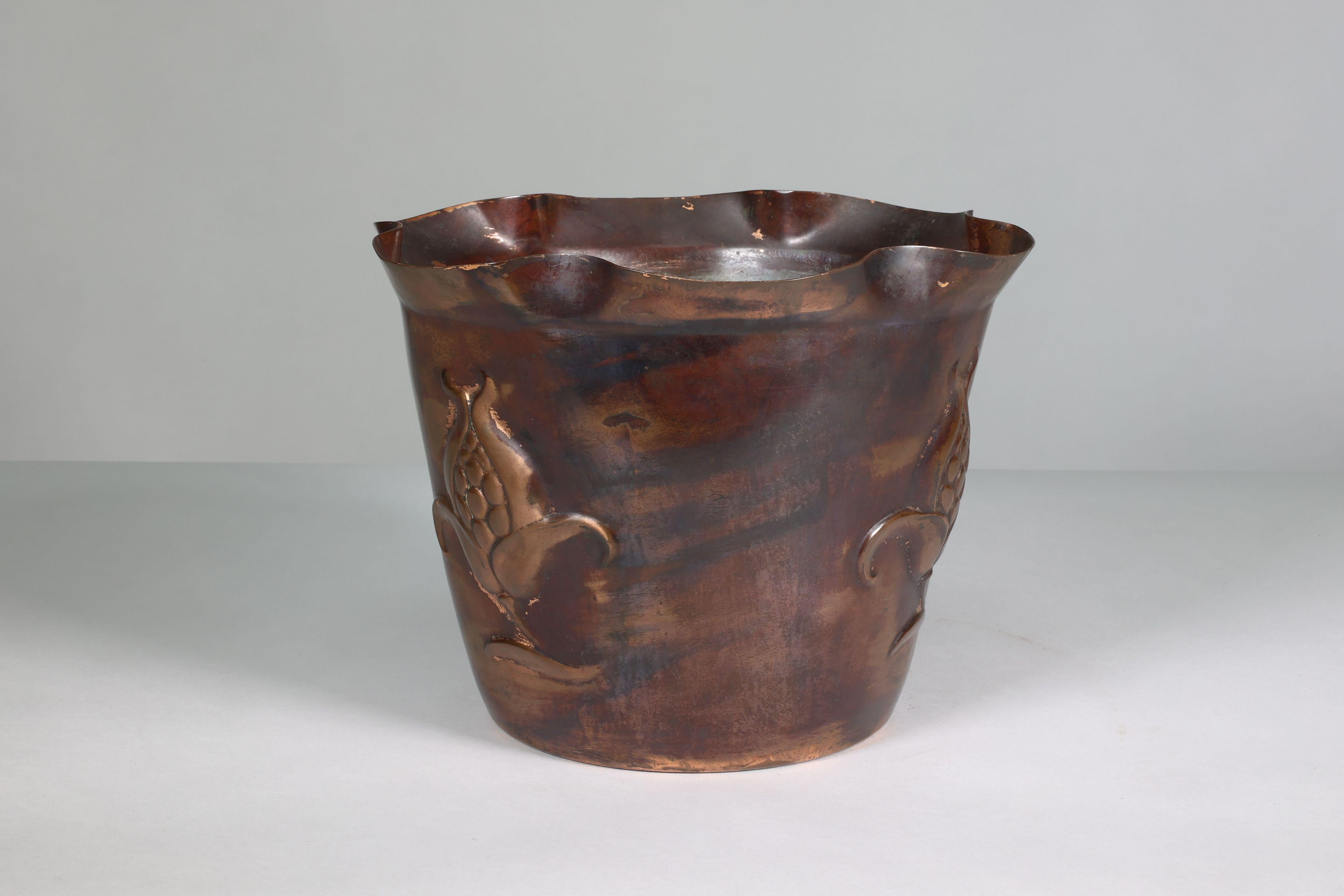 Joseph Sankey and Sons. A large Arts and Crafts heavy copper planter decorated with a flower head in seed. Stamped J S & S. Made in England. Solid Brass. RD 403903 for Circa 1903.